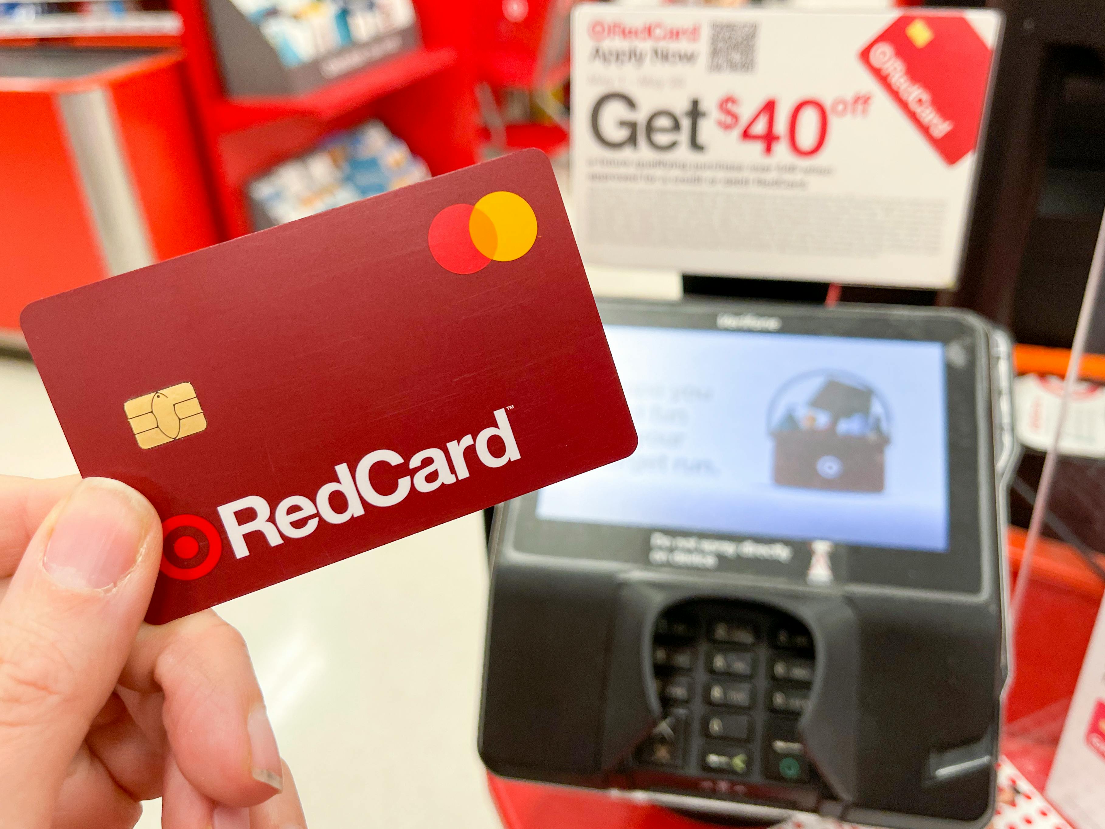 A Target RedCard held next to a credit card reader at Target checkout.
