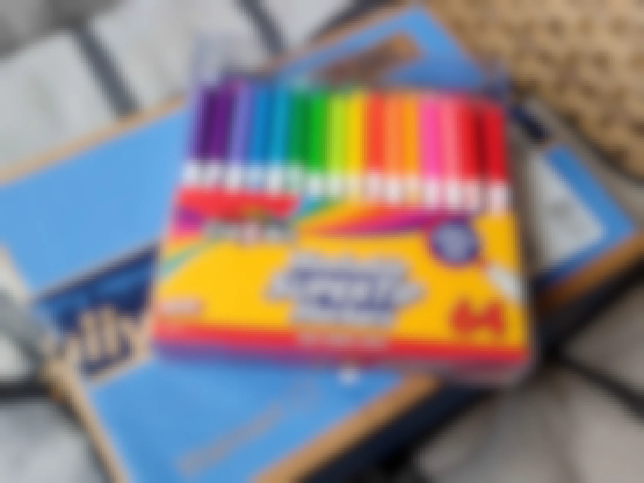 A 64 pack of Cra-Z-Art washable supertip markers on top of a Walmart delivery box.