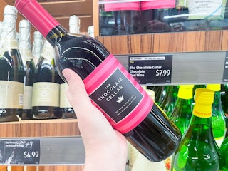 A person holding a wine bottle