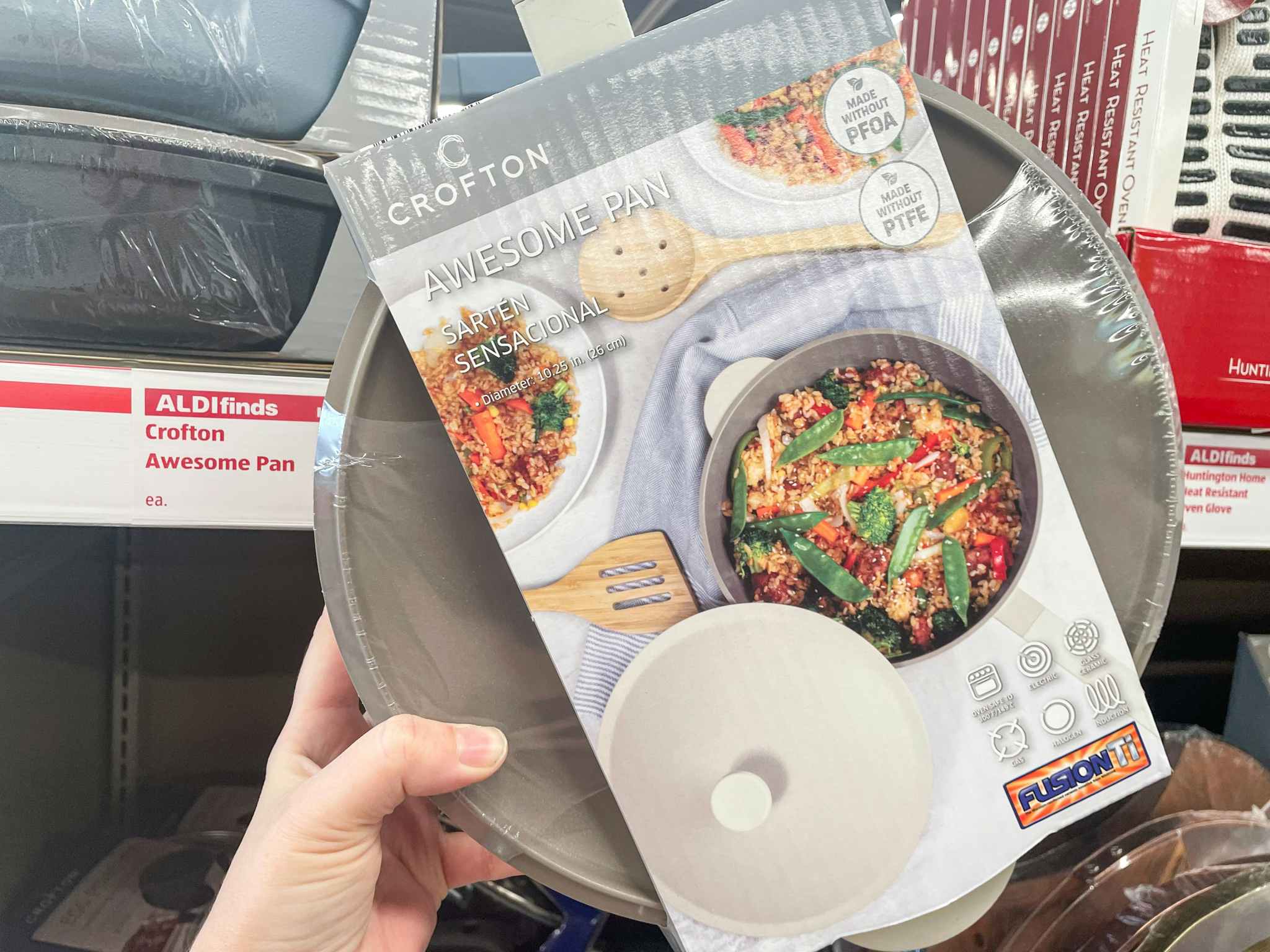 Someone holding up the Crofton Awesome Pan inside an Aldi