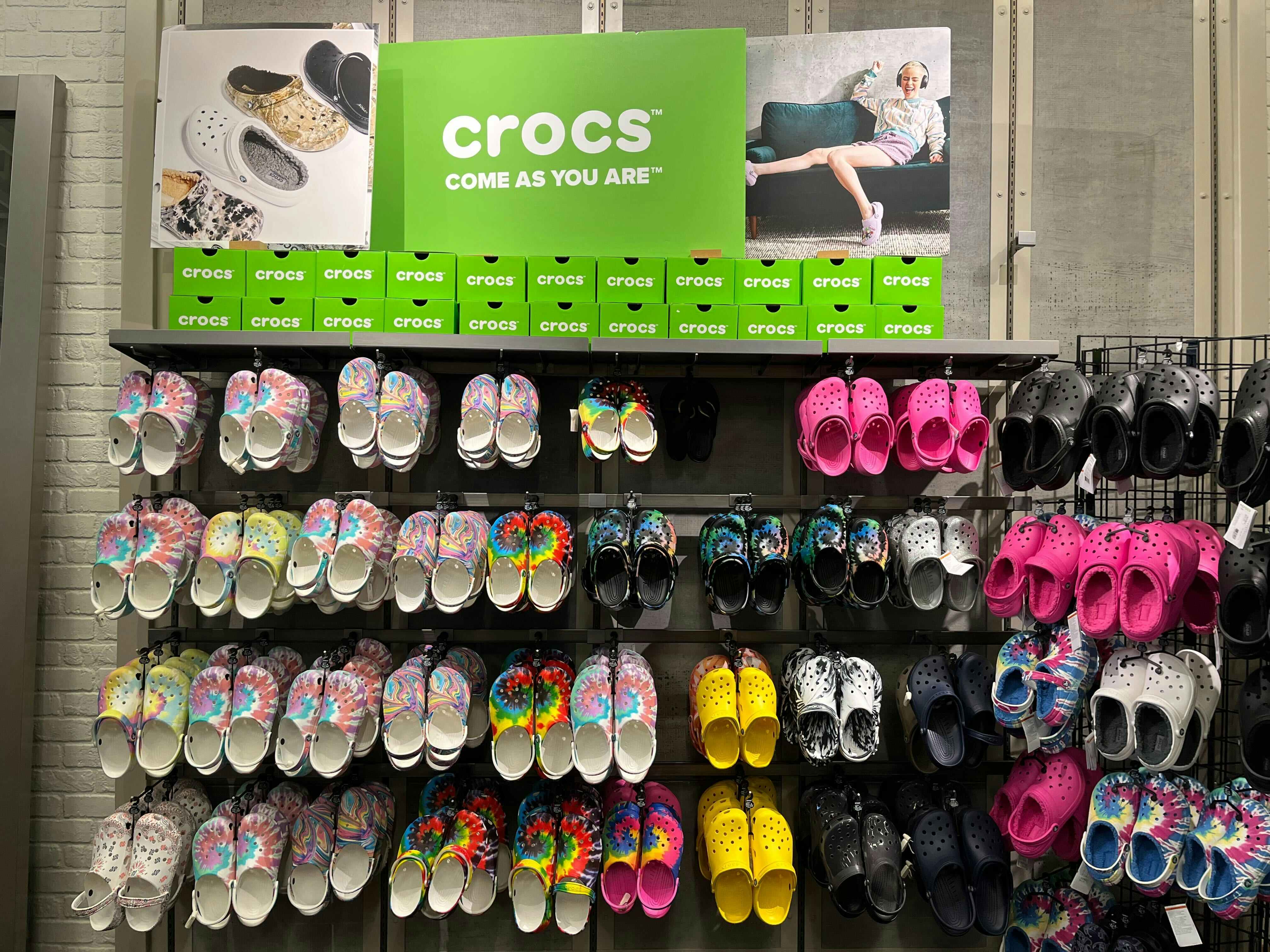 A wall of crocs shoes inside DSW.