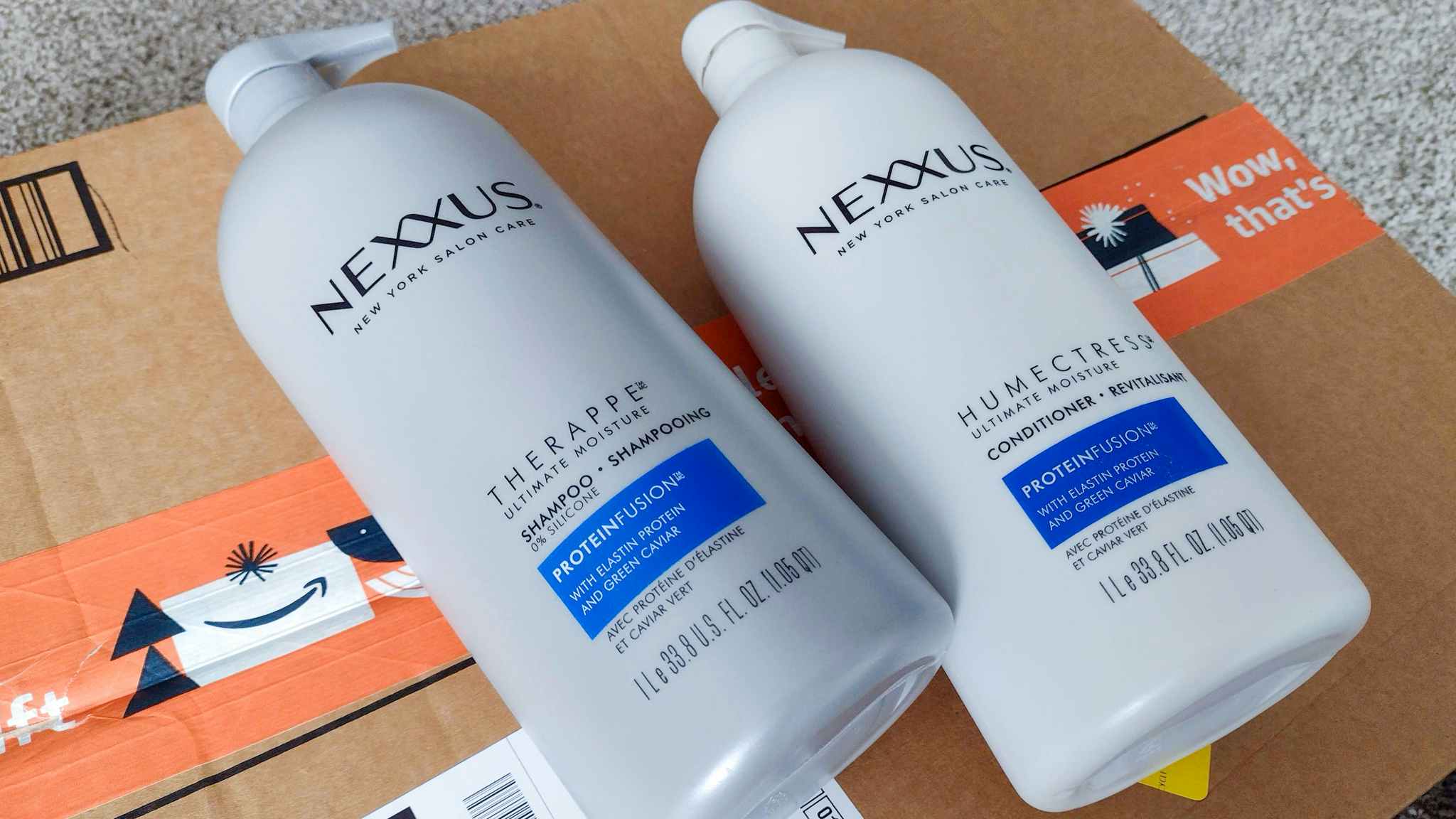 Nexxus shampoo and conditioner on top of an amazon box