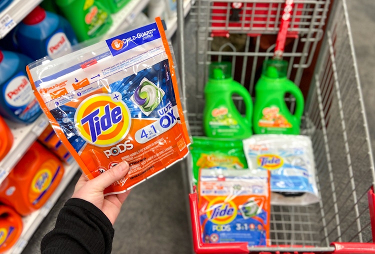 someone putting tide in cart