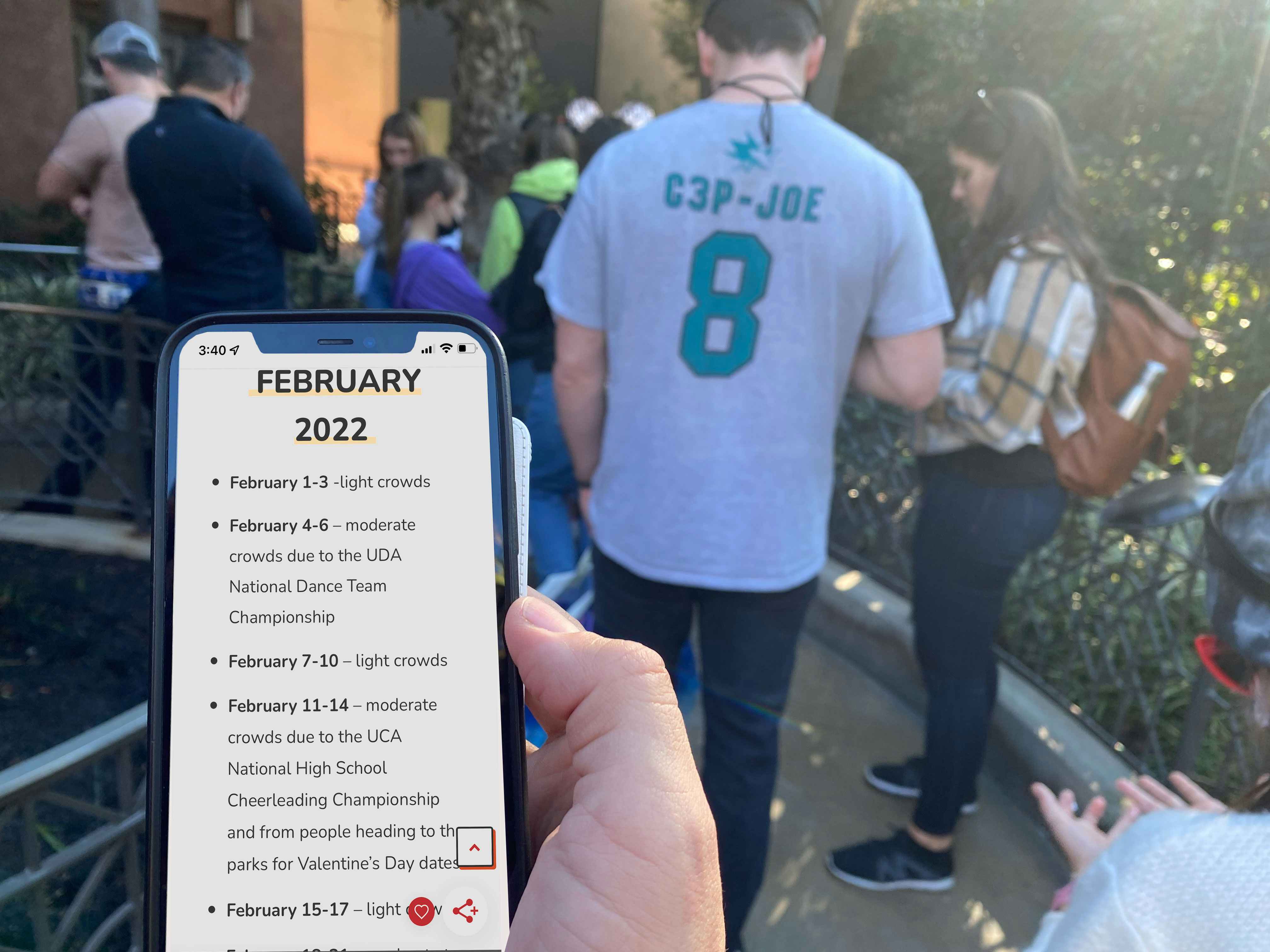 Person holds phone with Disney World Prep School calendar loaded.