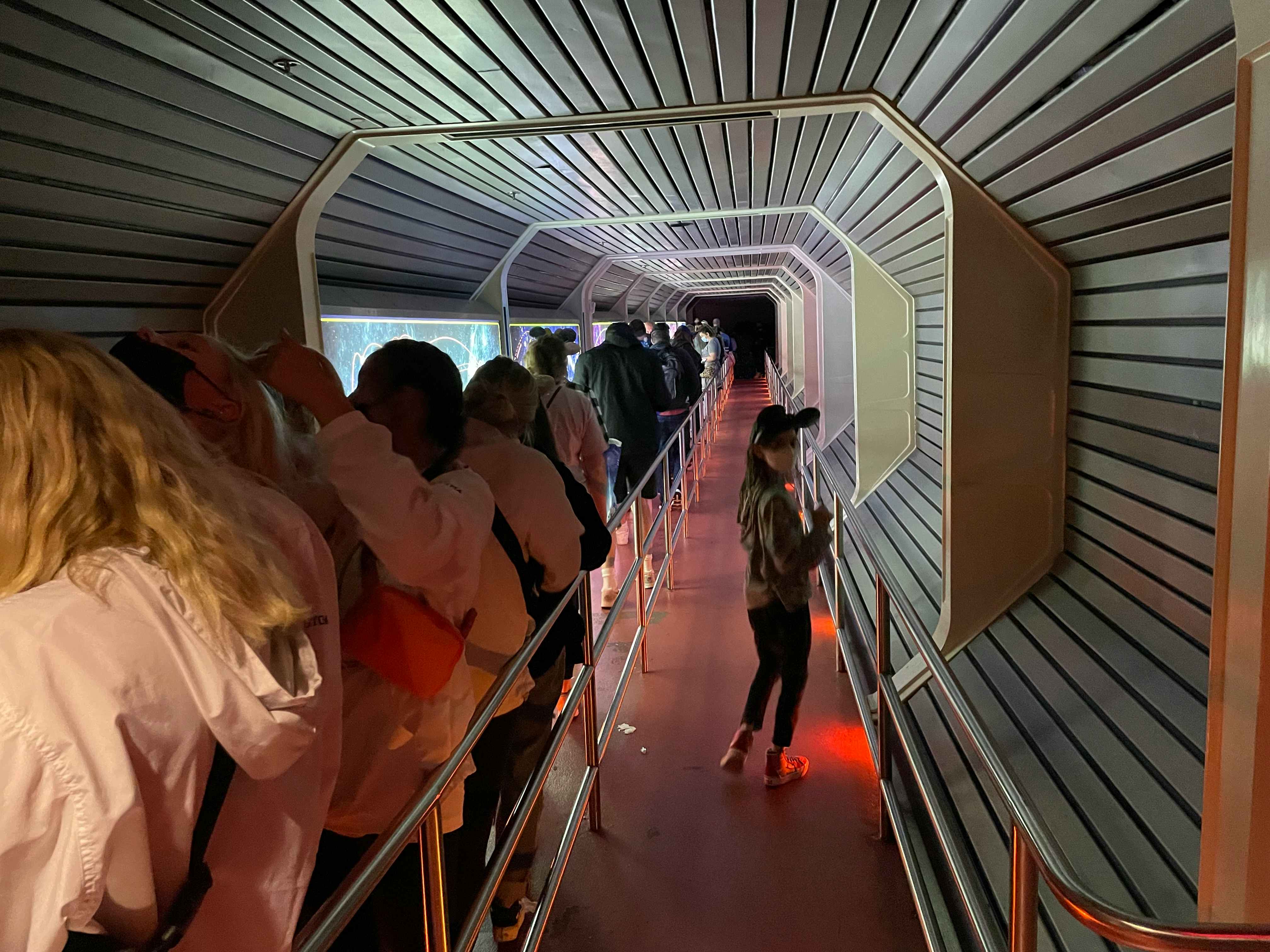 Kid in the Lightning Lane at Space Mountain while crowds fill the standby lane