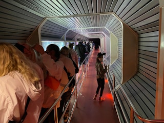 Kid in the Lightning Lane at Space Mountain while crowds fill the standby lane