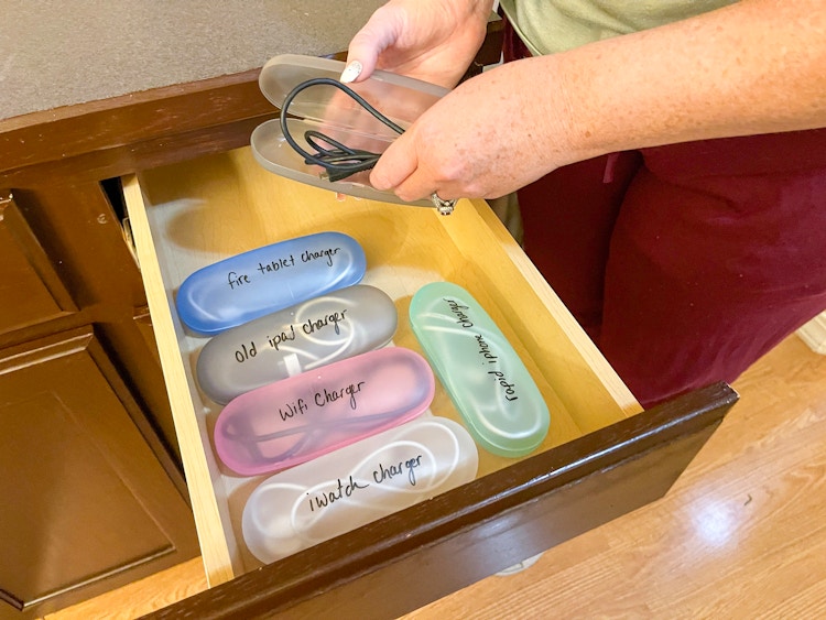 someone putting cords in glasses cases
