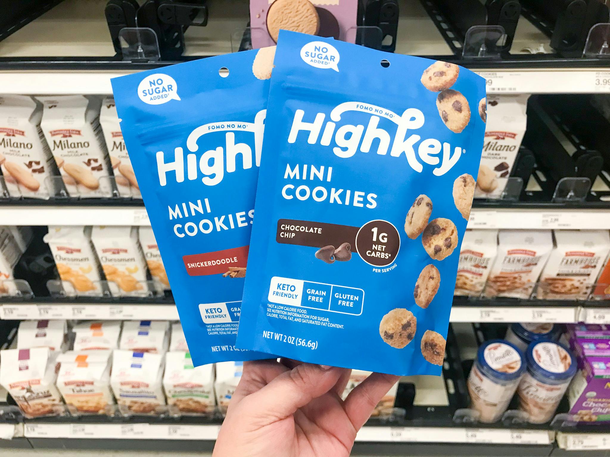 hand holding two bags of highkey cookies at target