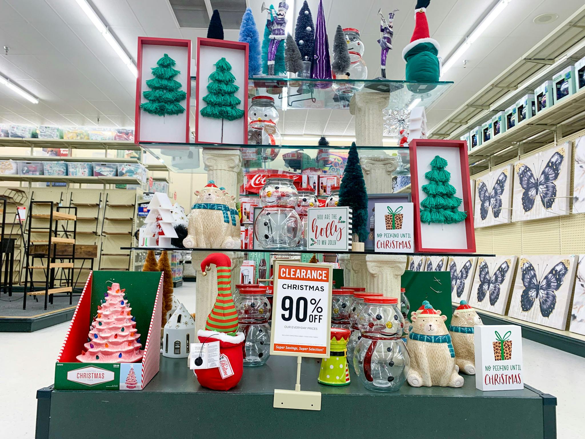 A Hobby Lobby Christmas clearance display with a 90% off sign in front.