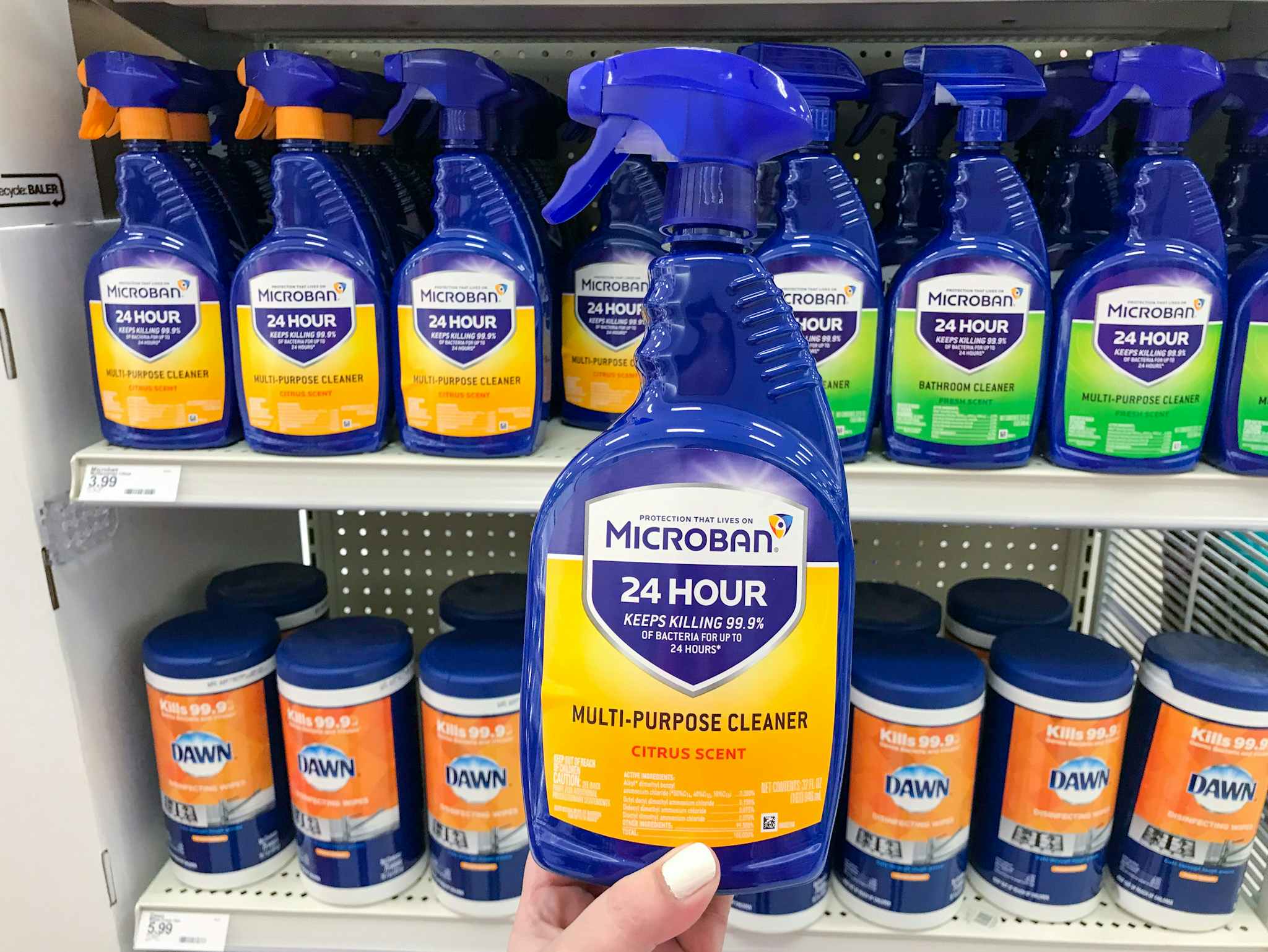 Hand holding a microban multipurpose spray at target