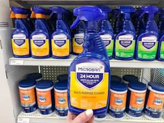 Hand holding a microban multipurpose spray at target