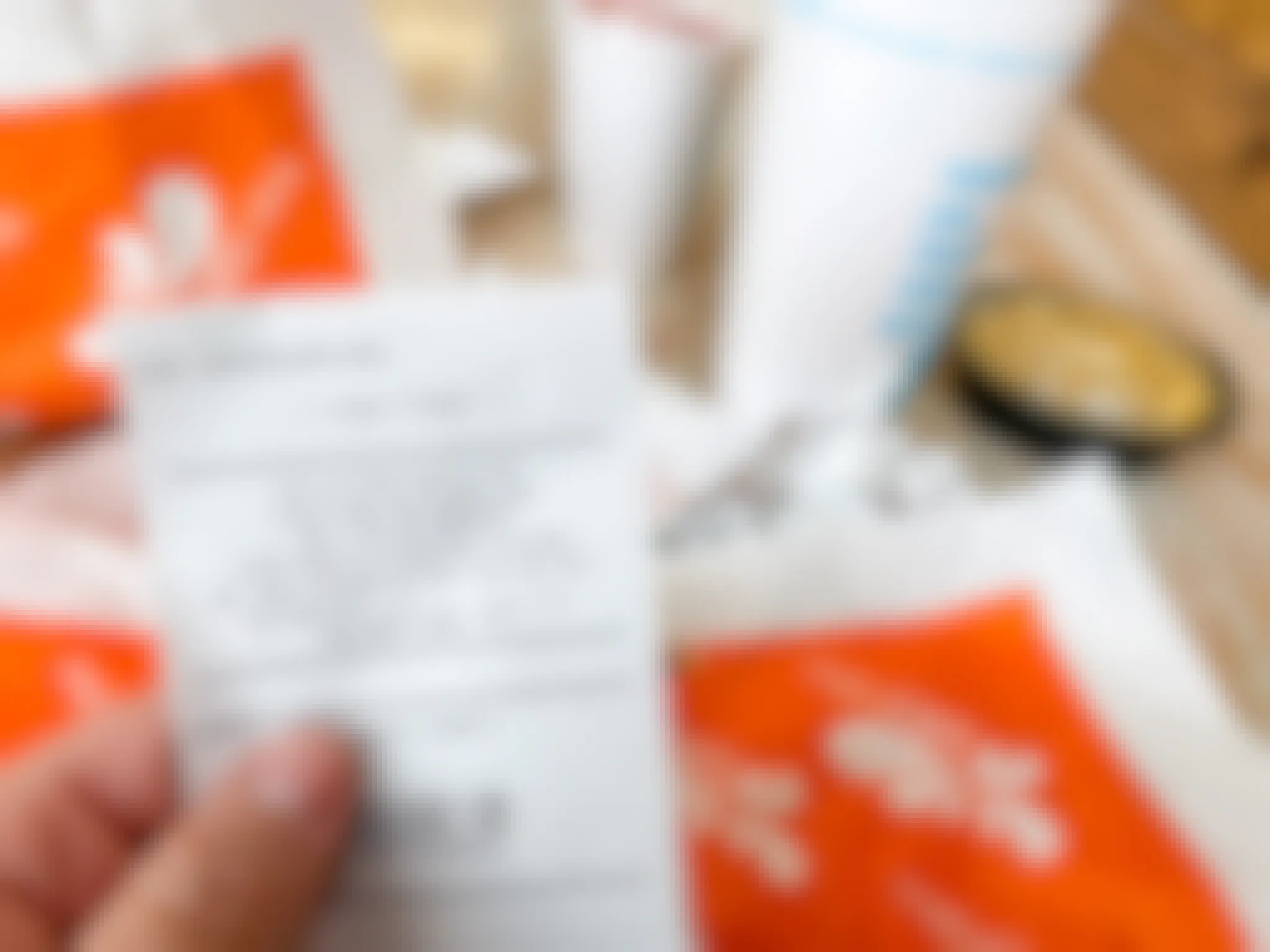 A person holding a Tropical Cafe smoothie receipt which gets them fast food deals next visit.