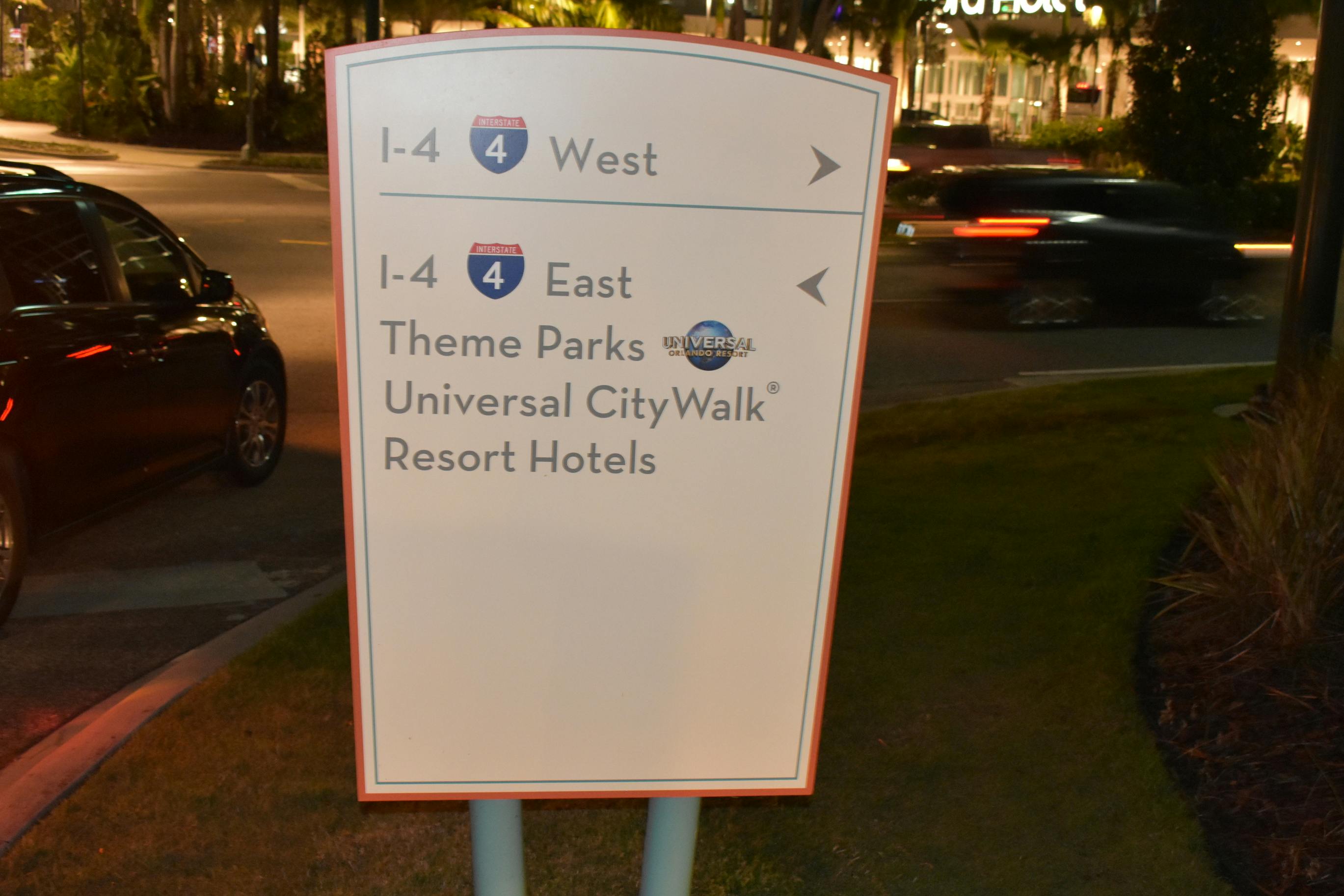 Universal Studios Orlando signage guiding people to parks, shops, hotels