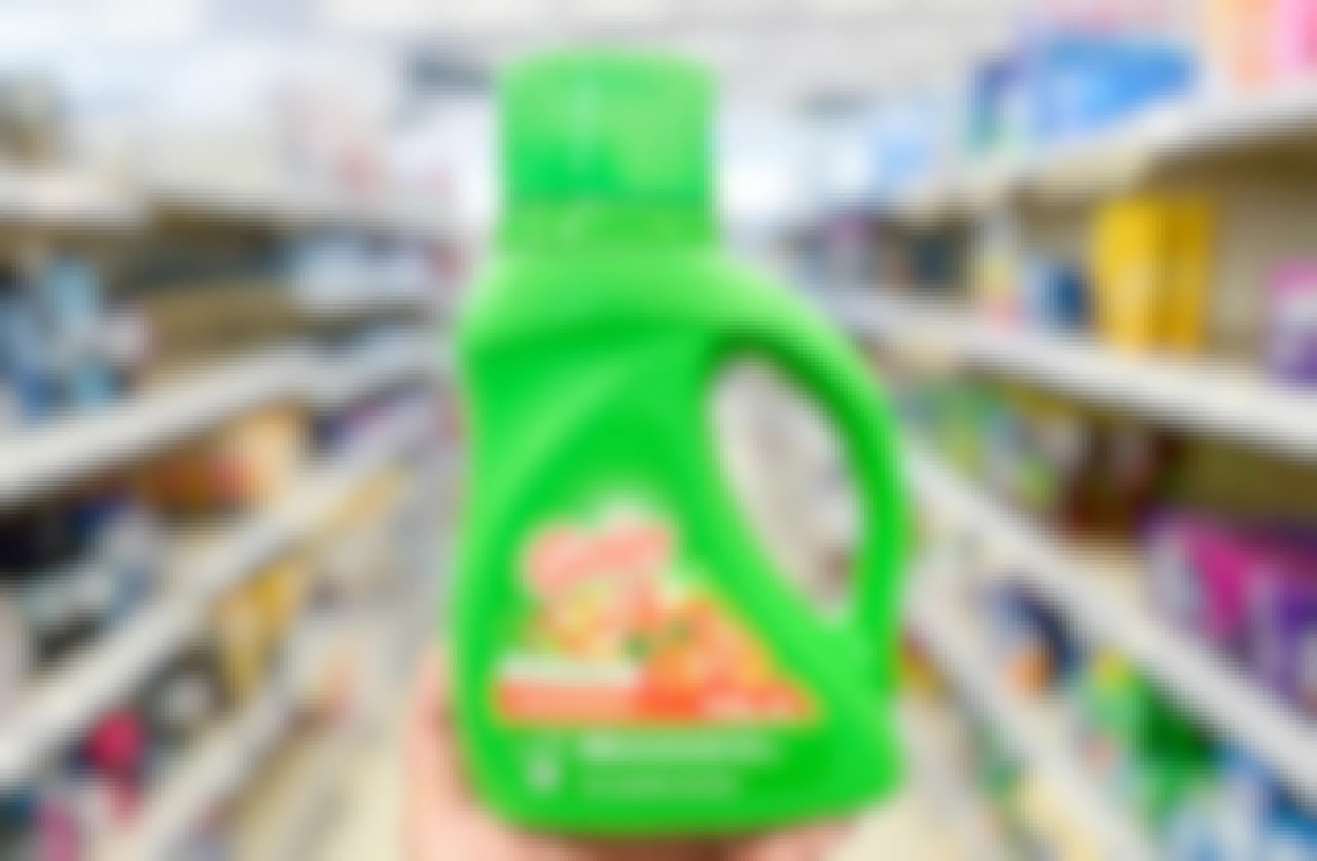 hand holding bottle of Gain in aisle