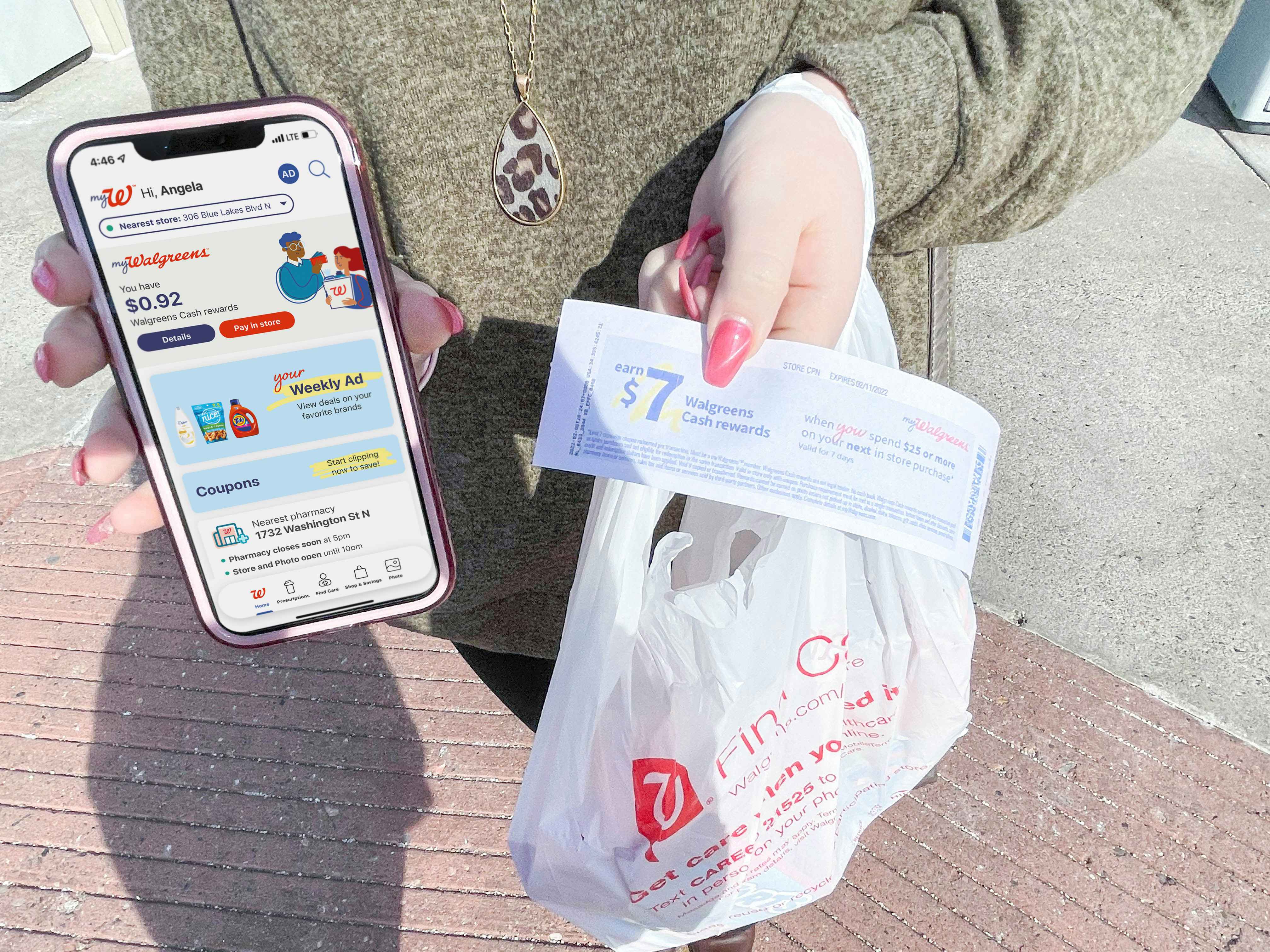 woman holding cellphone with mywalgreens app in one hand and cash rewards and bag in other 
