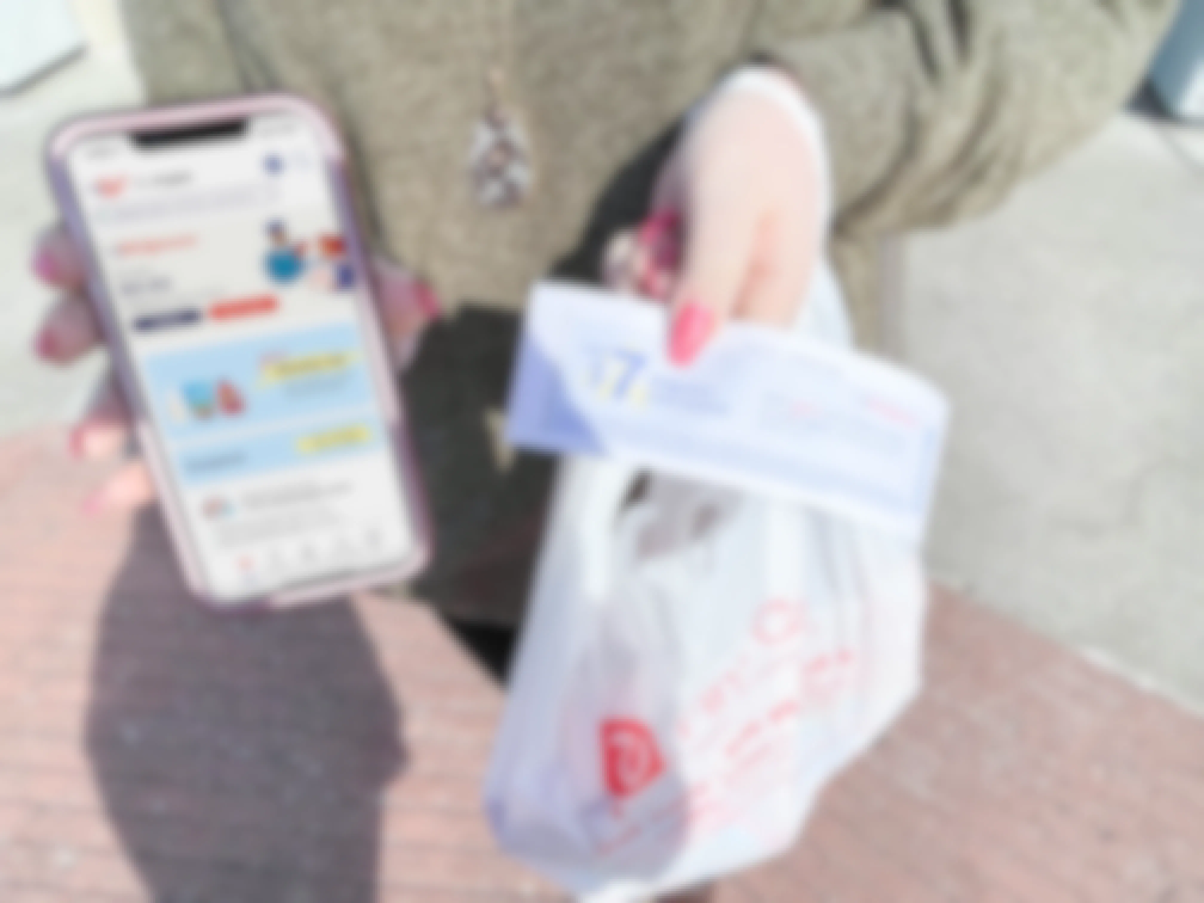 woman holding cellphone with mywalgreens app in one hand and cash rewards and bag in other 