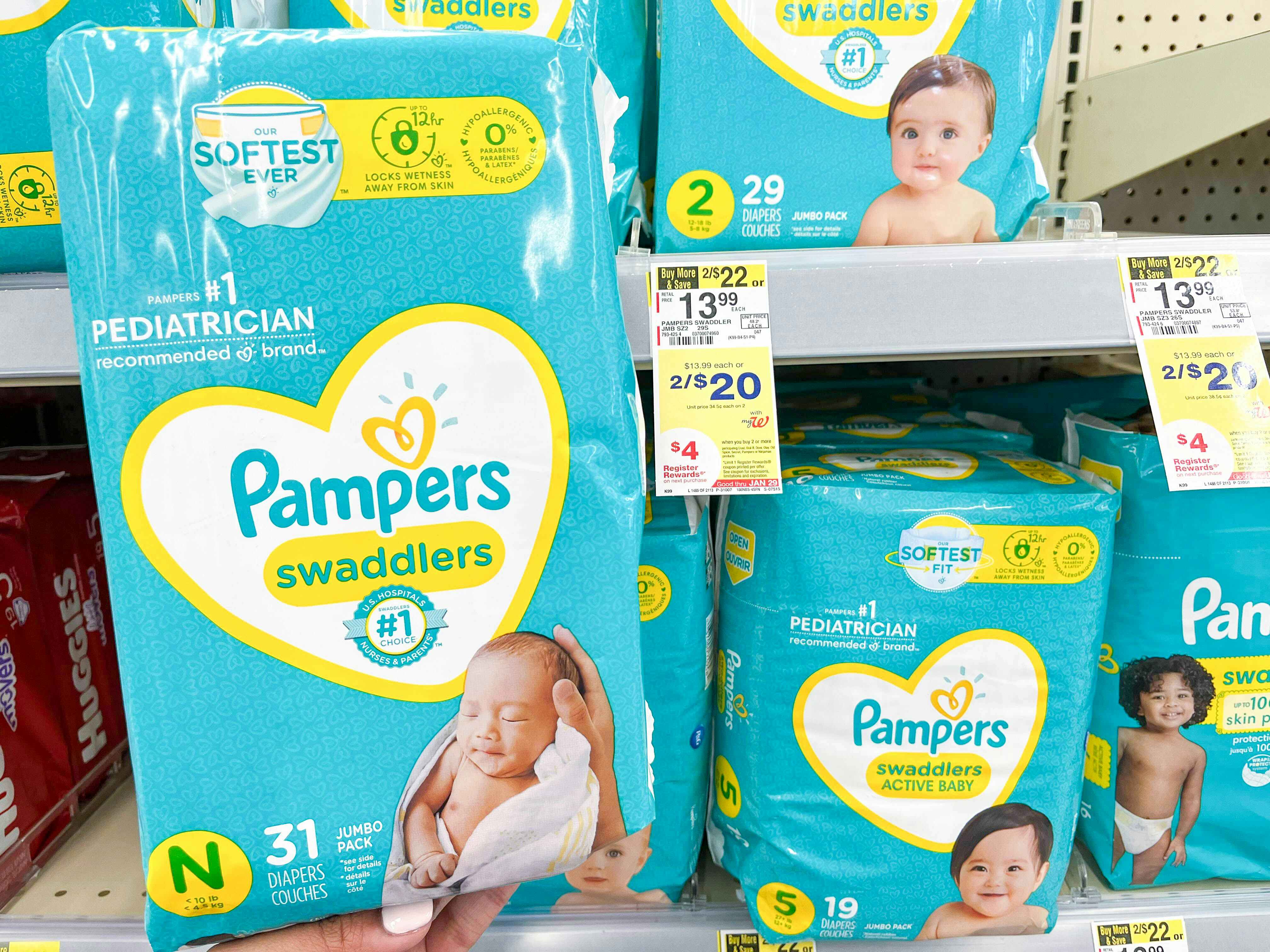someone holding Pampers swaddlers