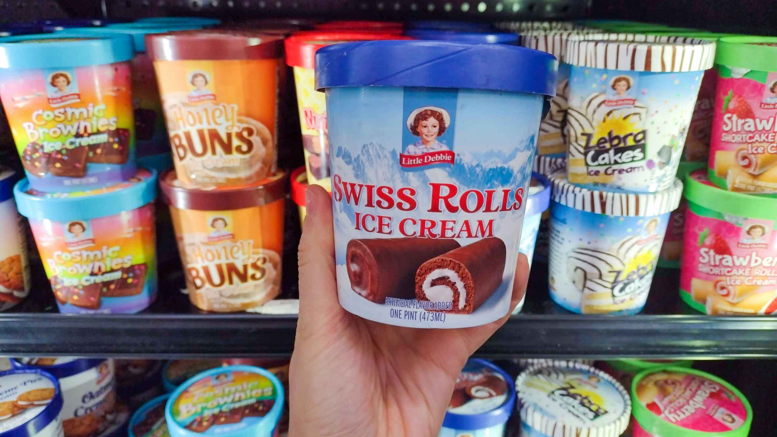 walmart little debbie ice cream hand holding swiss rolls