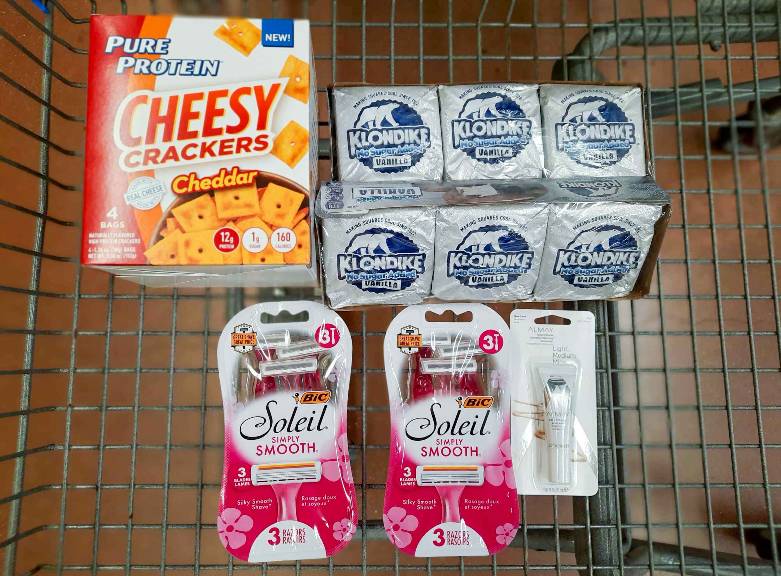 Pure Protein Crackers, Klondike Zero Sugar, Bic Razors, and Almay Concealer in Walmart shopping cart