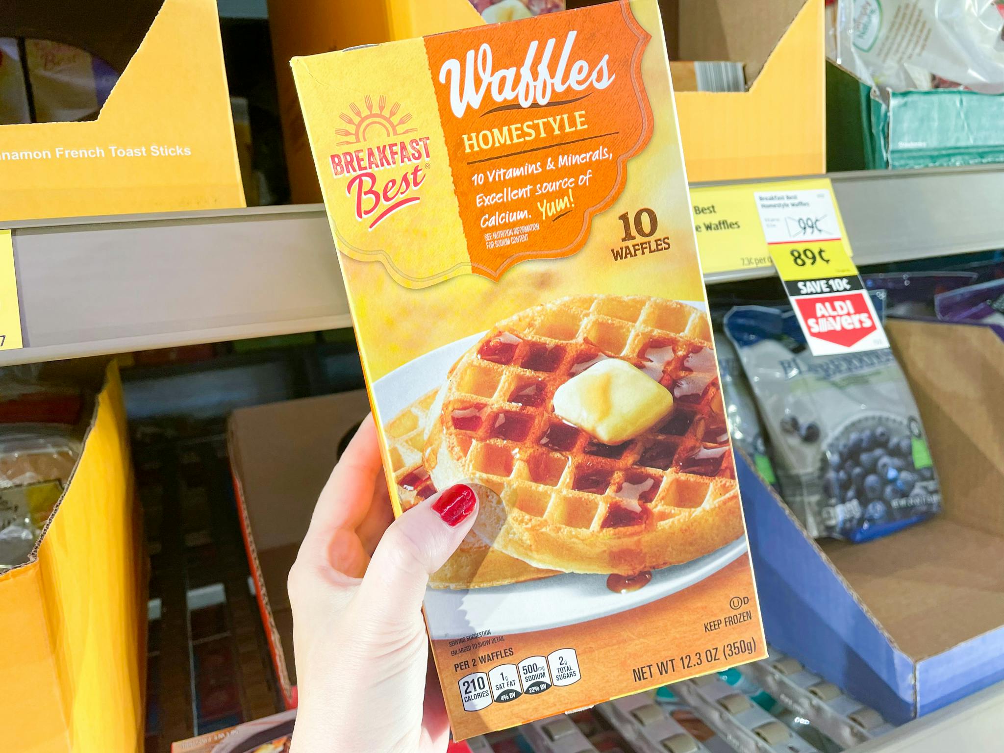 Someone holding a box of Breakfast Best waffles in ALDI