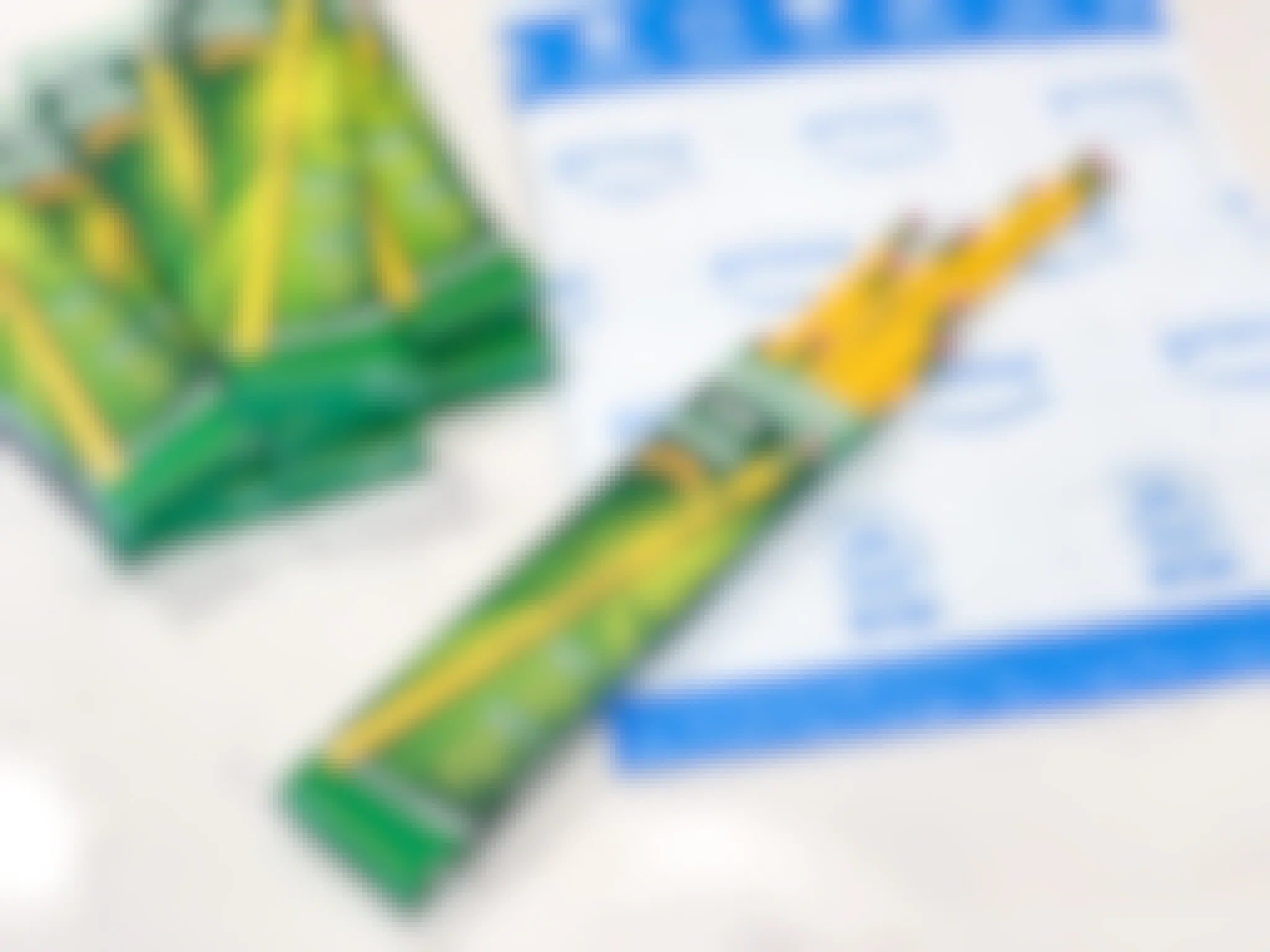 Ticonderoga pencils spilling out of their box on top of an Amazon mailing envelope on a table next to more boxes of Ticonderoga pencils.