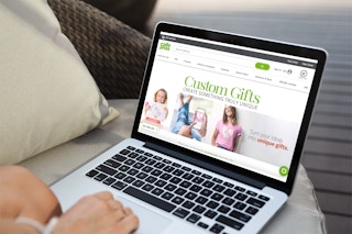 Woman using laptop with the Cafe Press creator's website on the screen