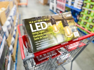 a shopping cart with one box of outdoor string lights