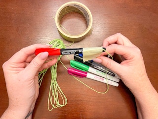 taping string to a marker