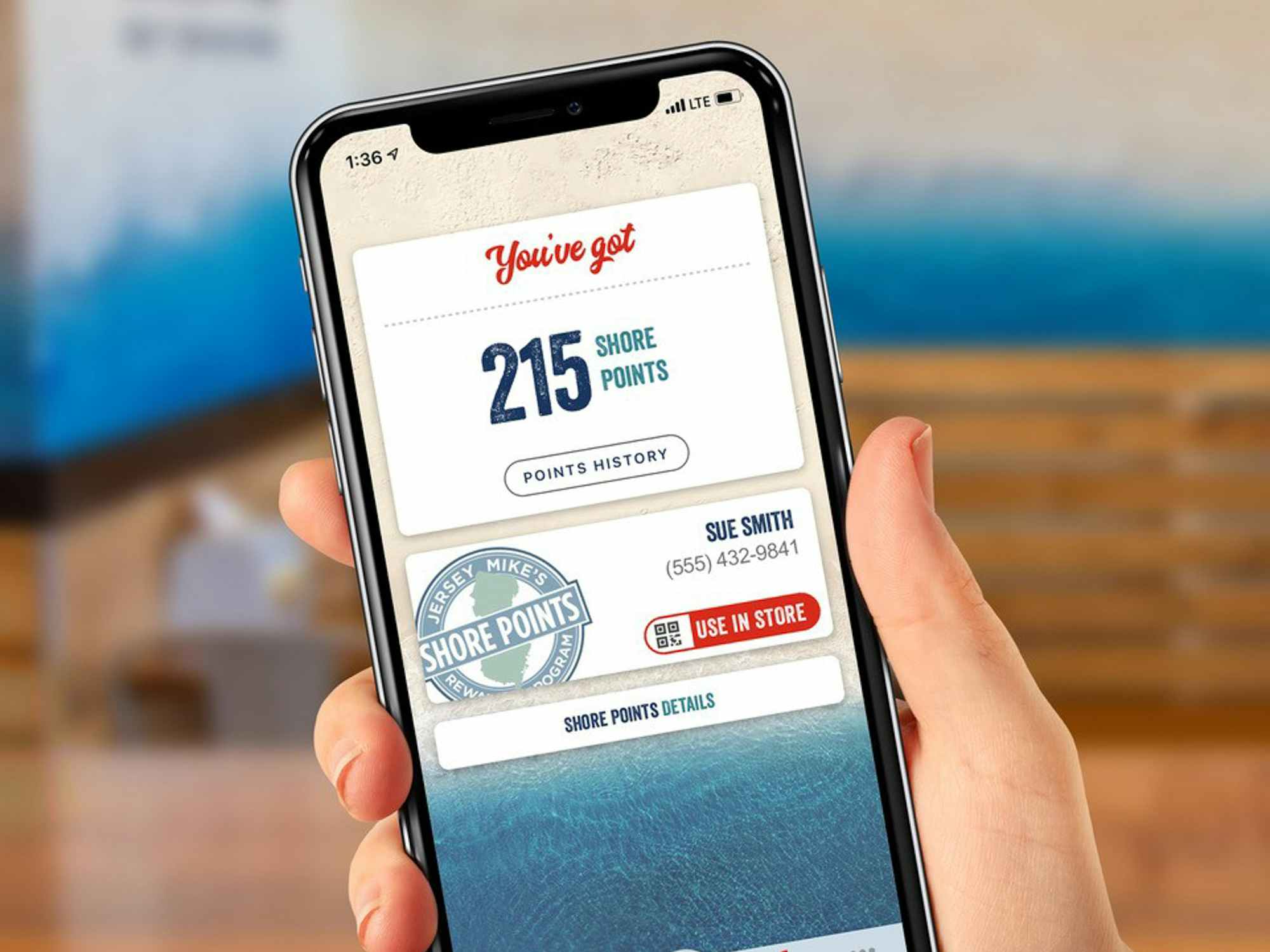 Someone holding a phone displaying the points in their Jersey Mike's rewards app