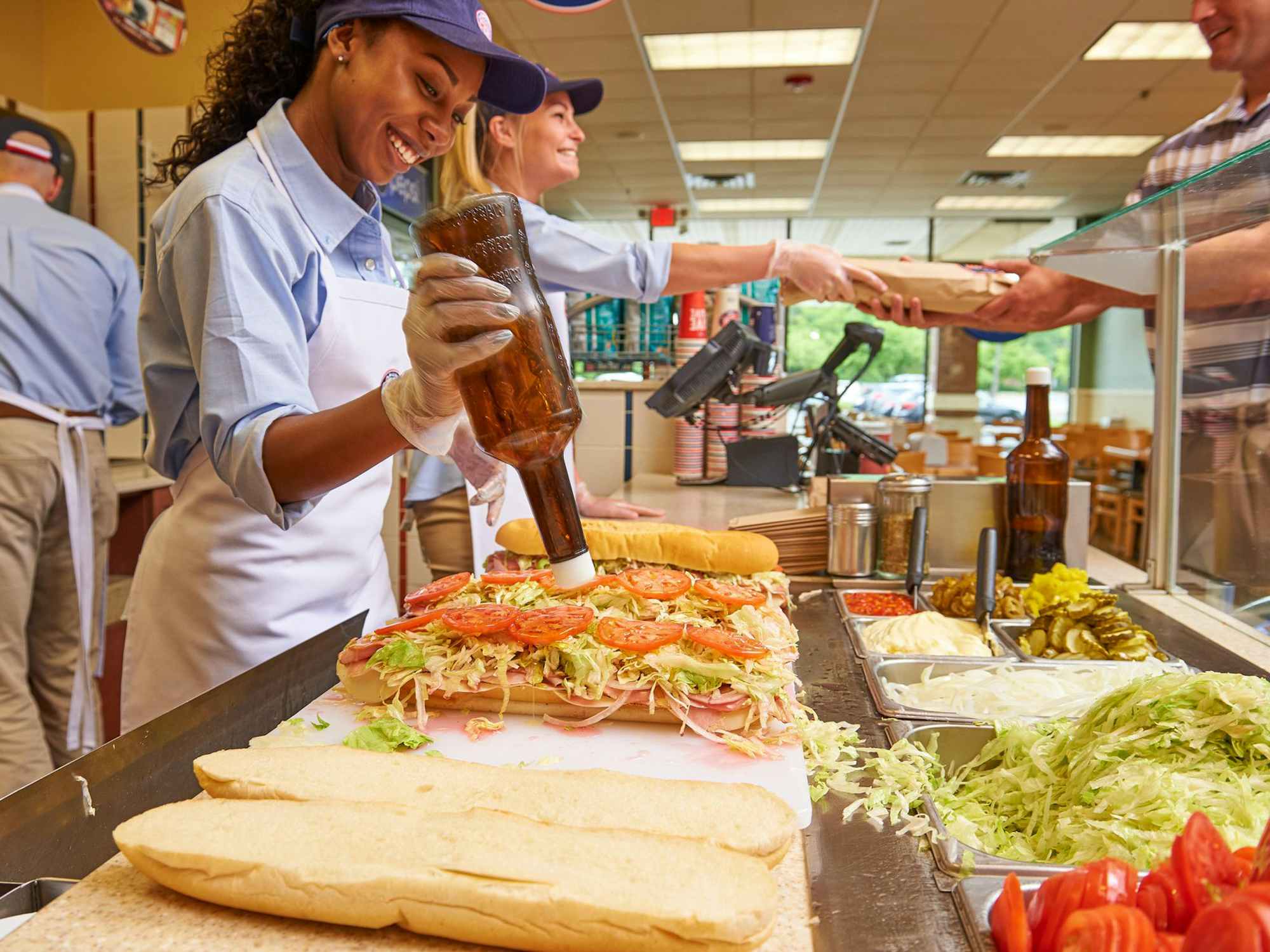 Jersey Mike's employees making subs for customers