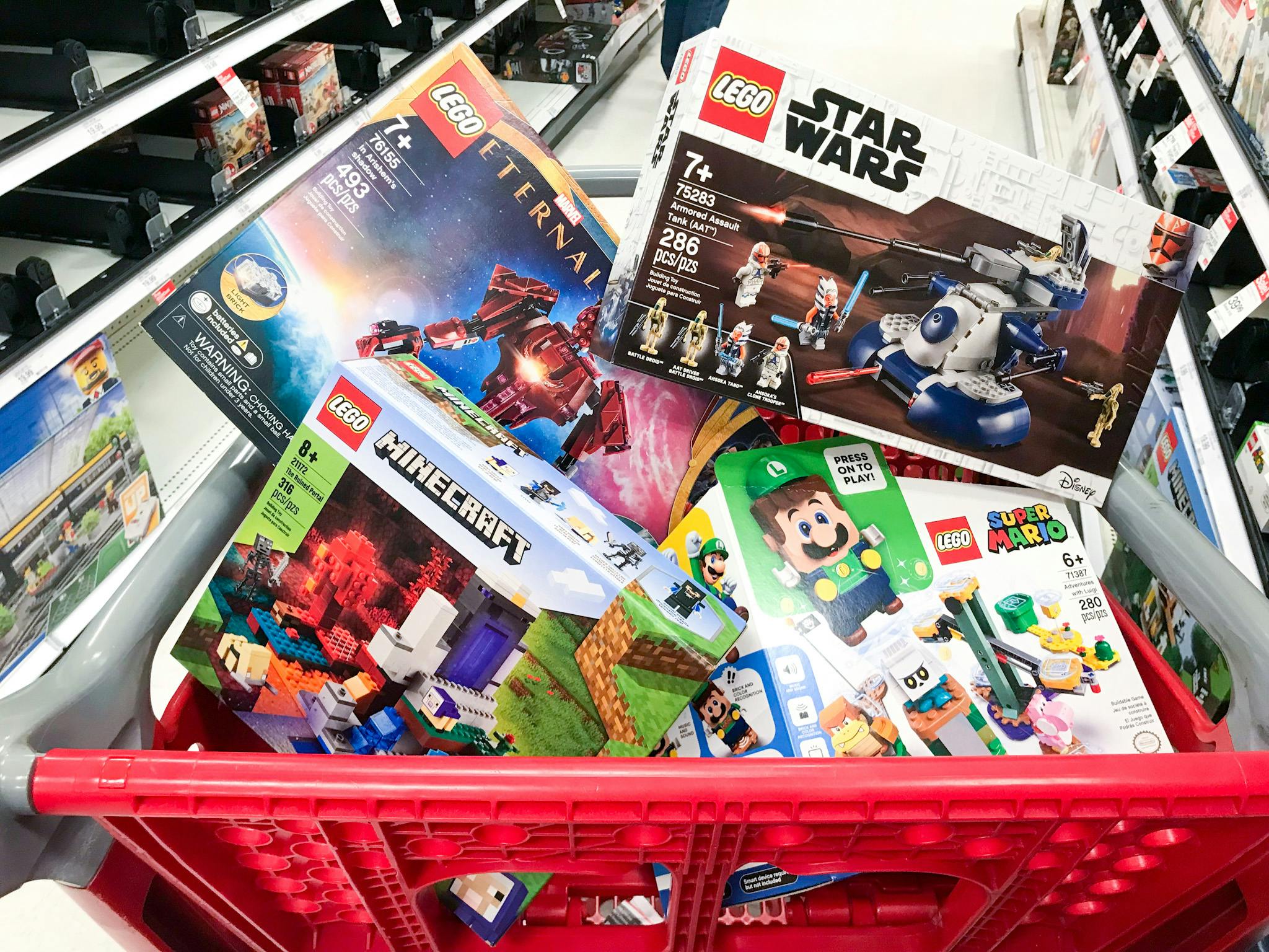 A Target shopping cart basket filled with LEGO toys.