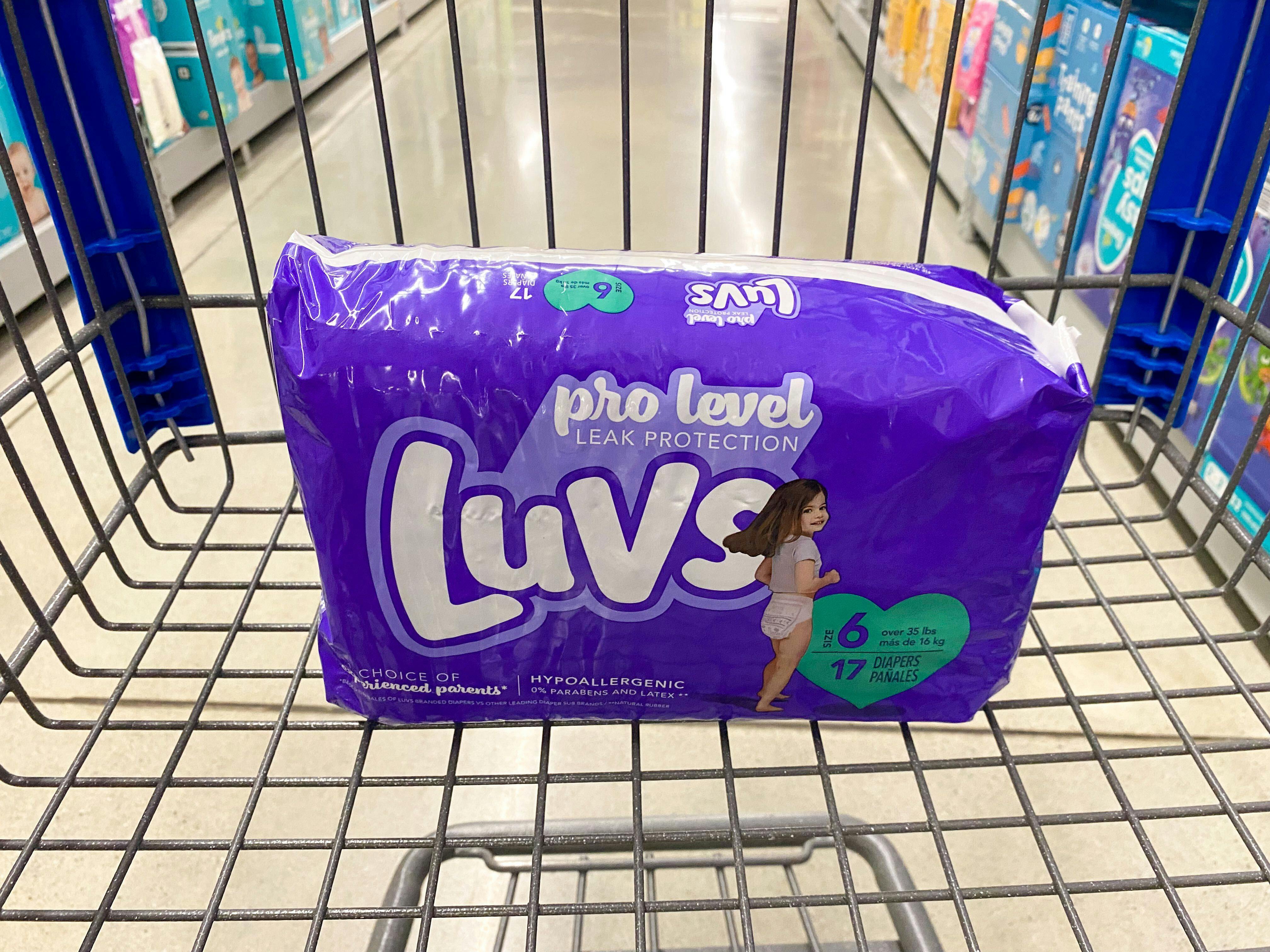A package of Luvs pro level diapers sitting in a Walmart shopping cart in the diaper aisle at Walmart.