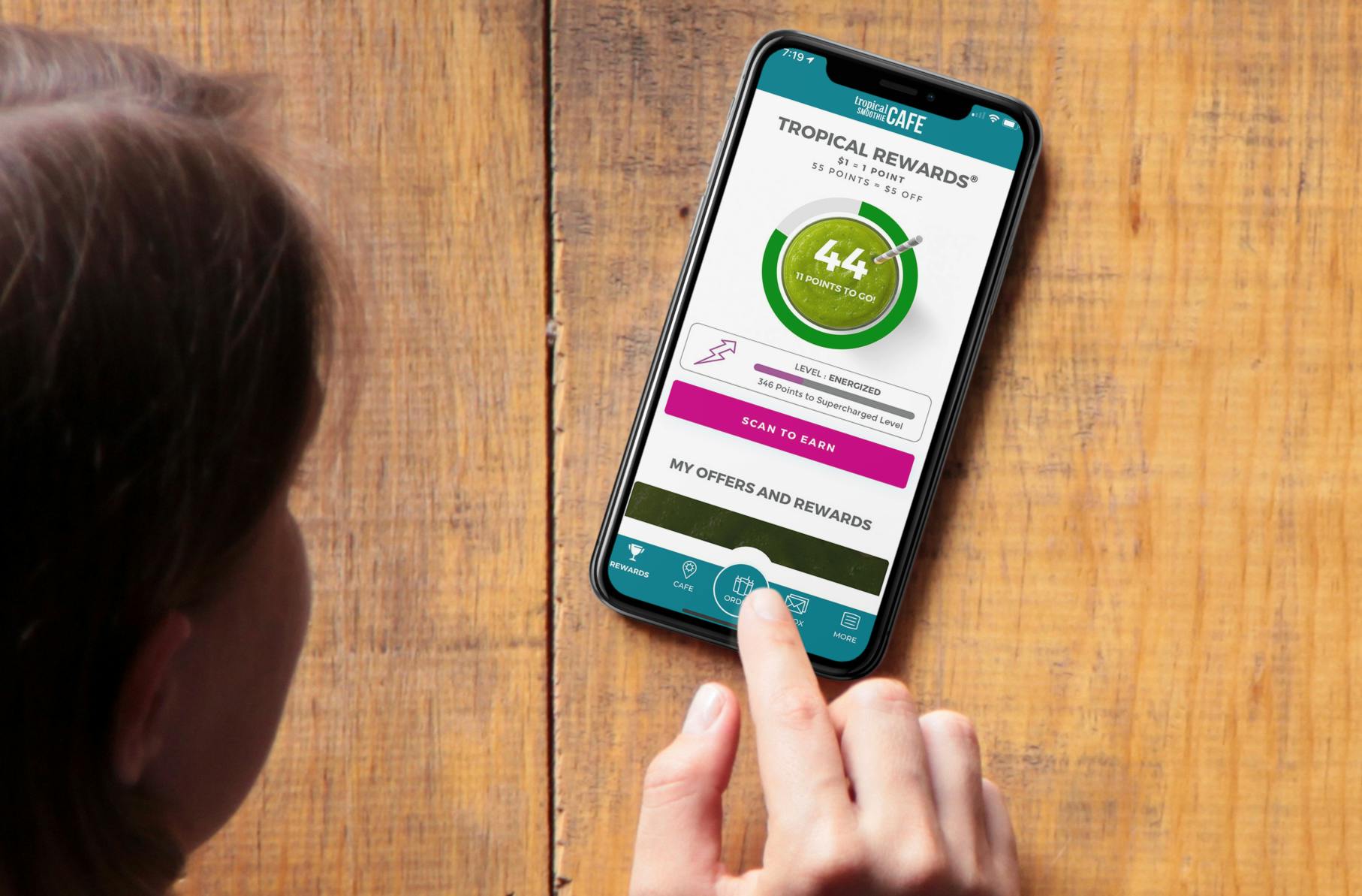 Woman looking at Tropical Smoothie Cafe app rewards page