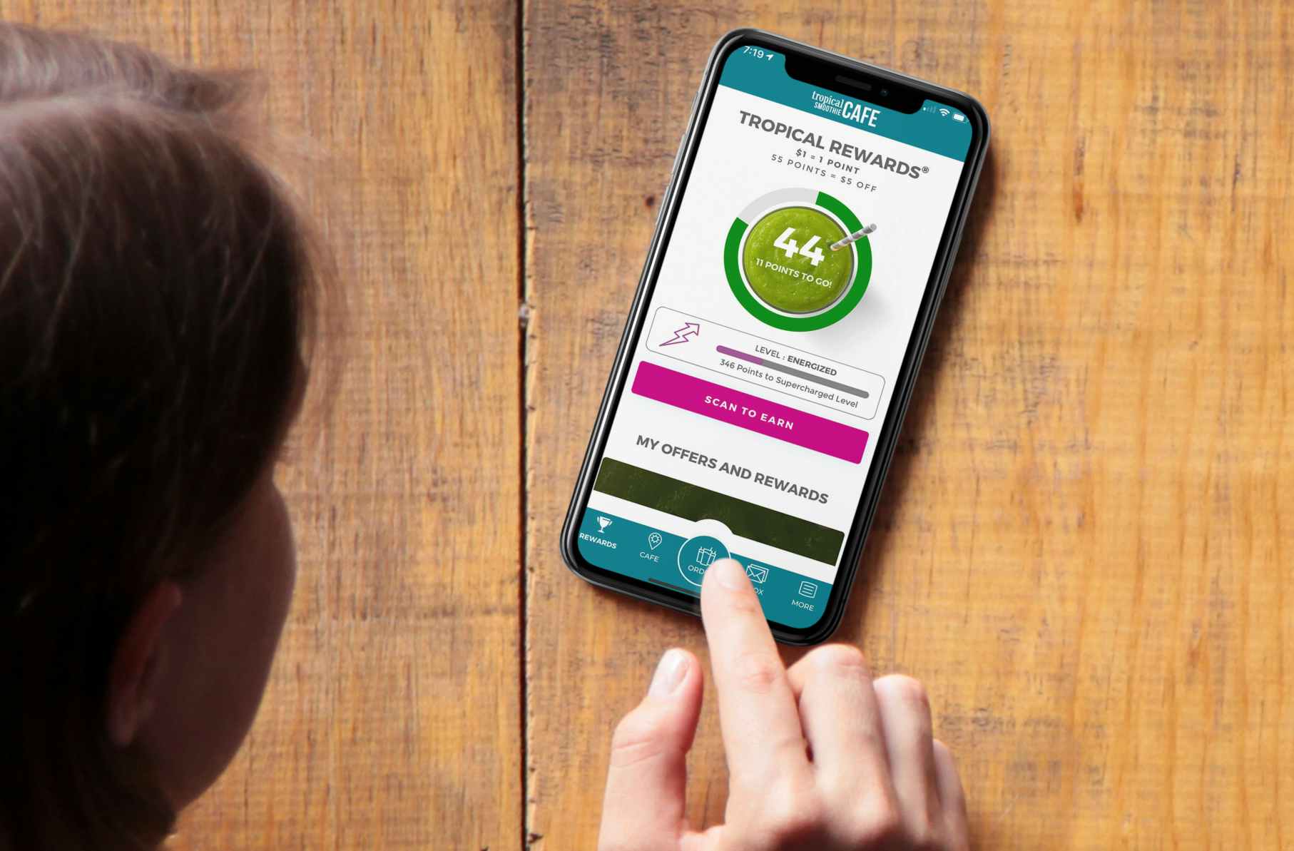 Woman looking at Tropical Smoothie Cafe app rewards page
