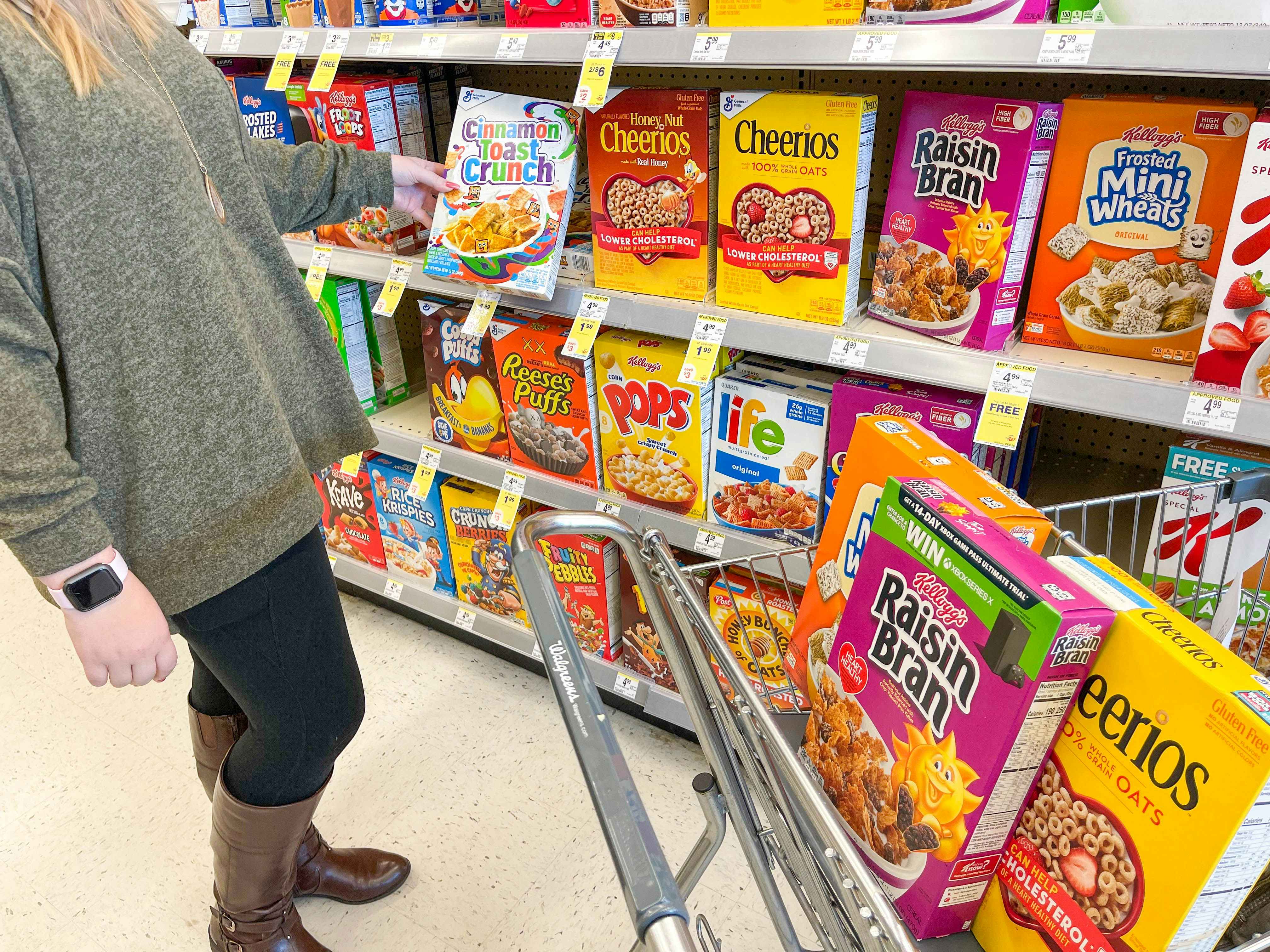 Person putting cereal in Walgreen's cart