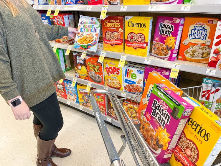 Person putting cereal in Walgreen's cart