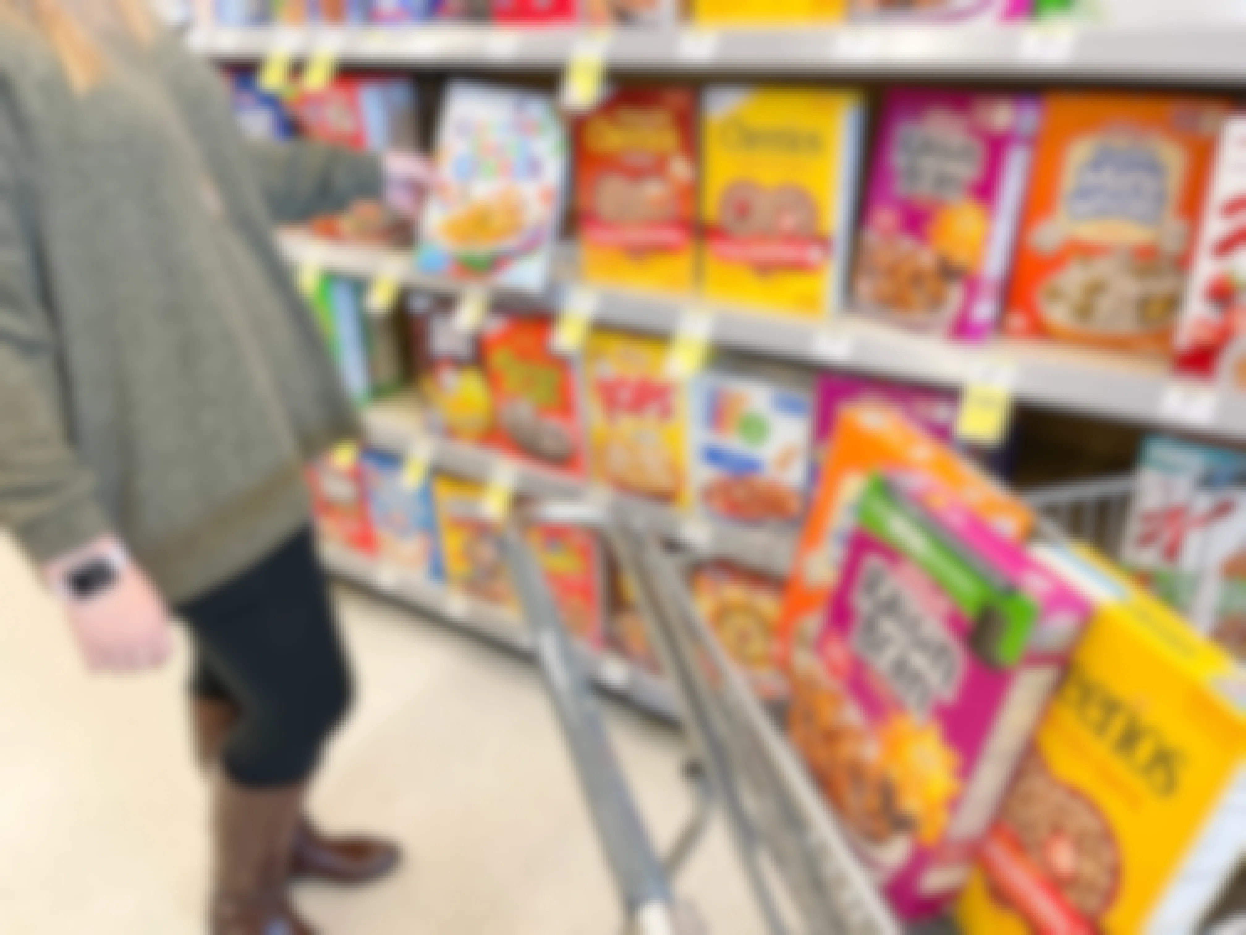Person putting cereal in Walgreen's cart