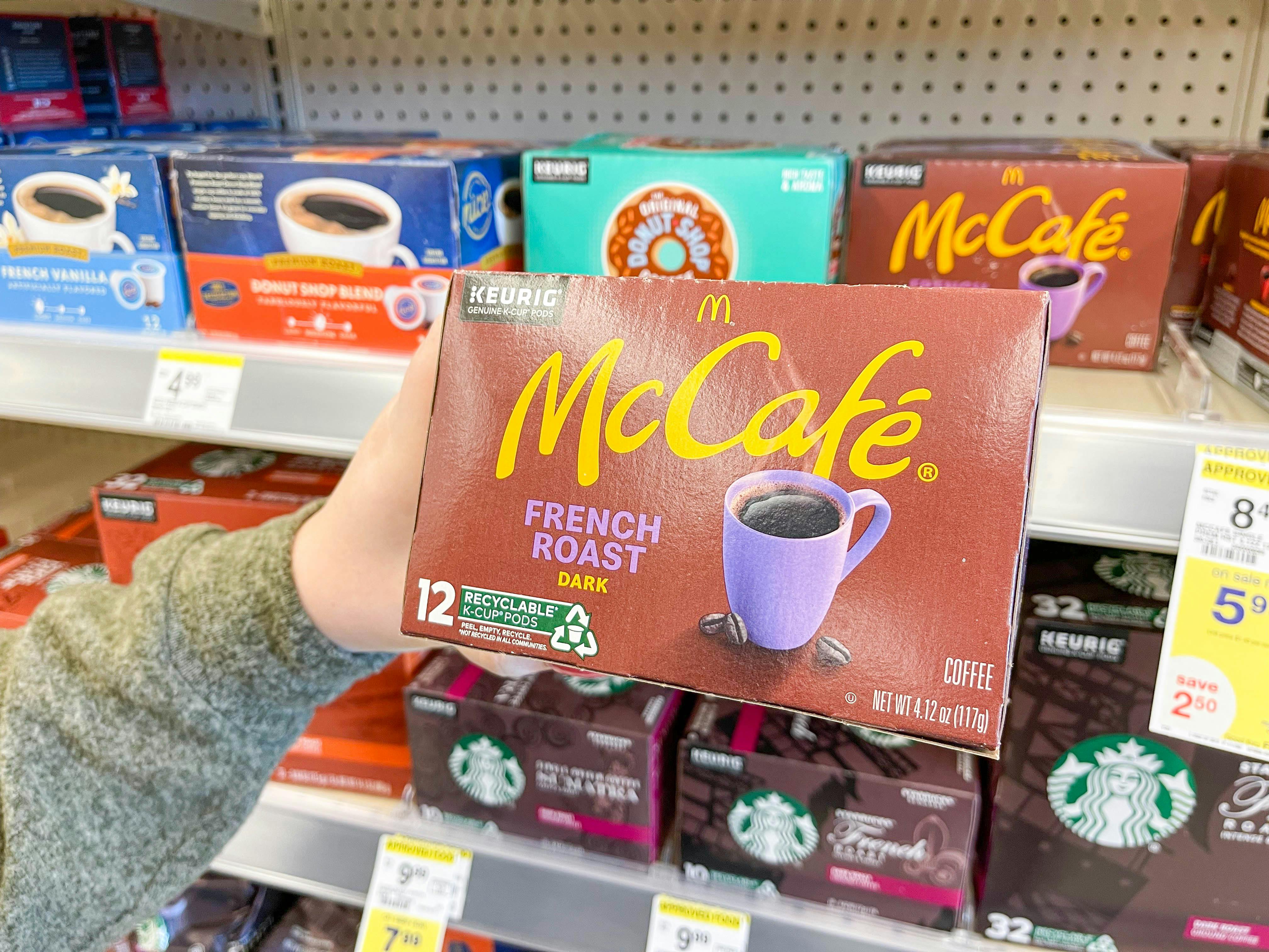woman holding kcups off store shelf