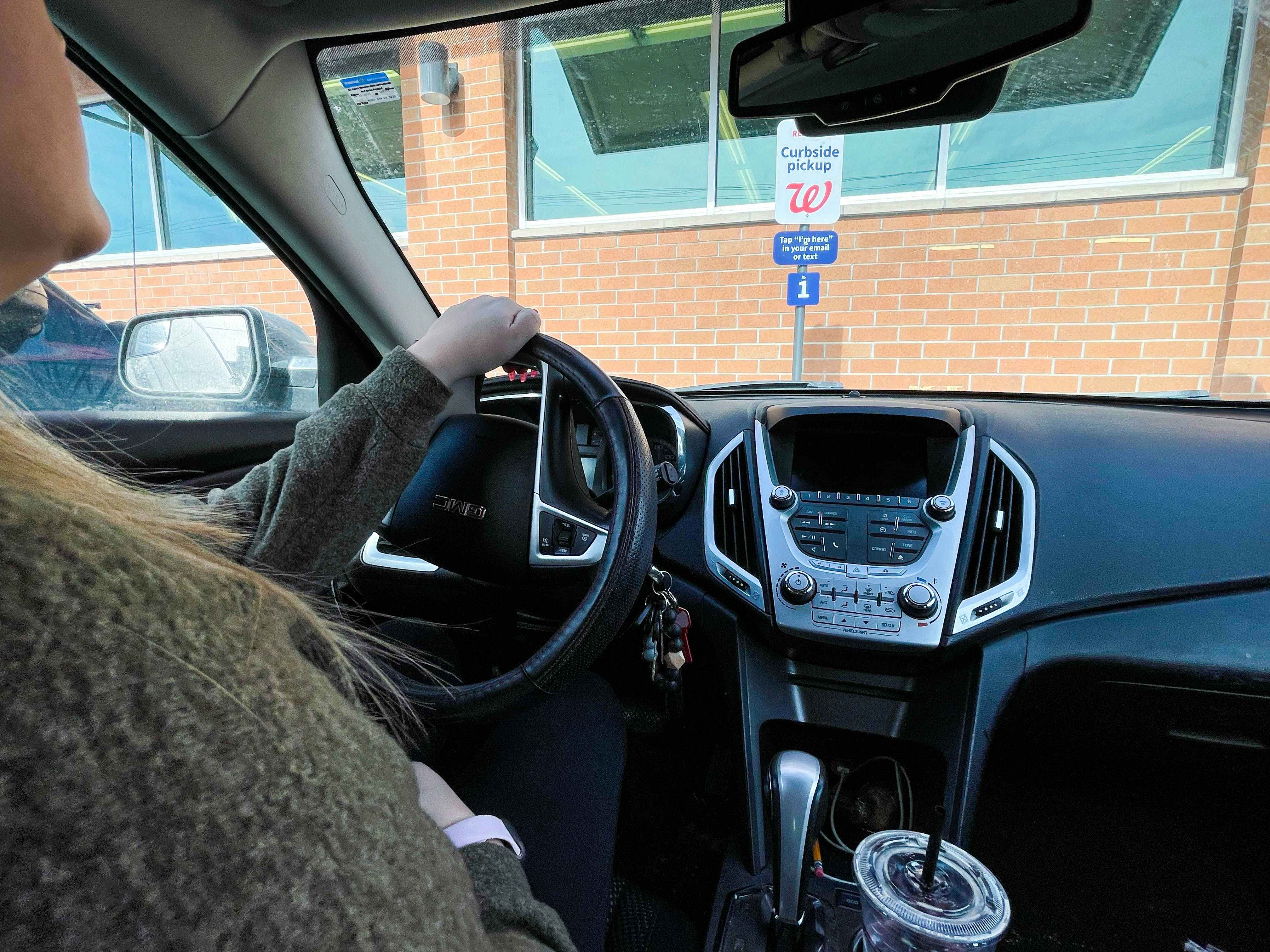 women in car at walgreens curbside pick up