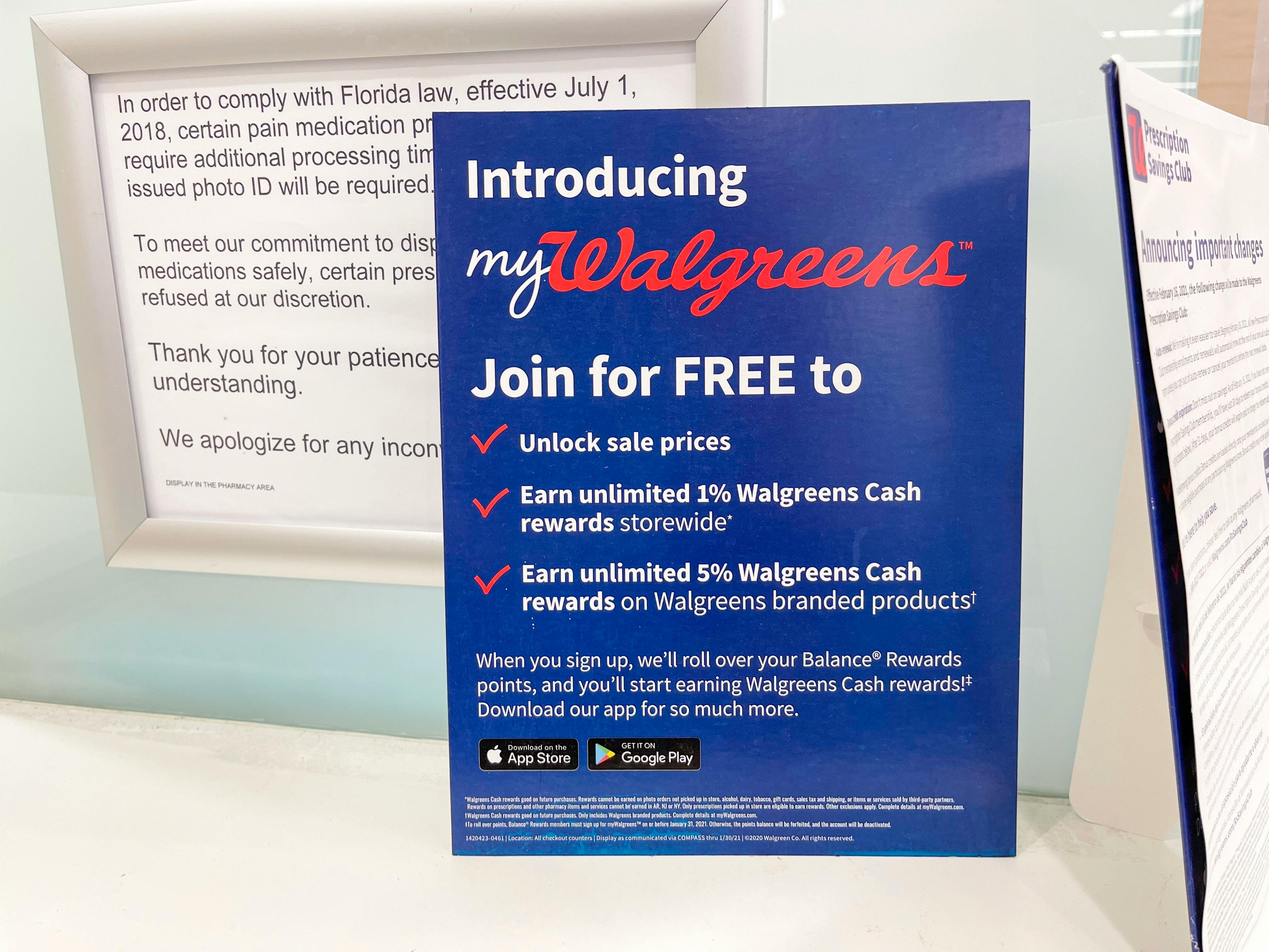 A sign for the myWalgreens rewards program on a counter in walgreens