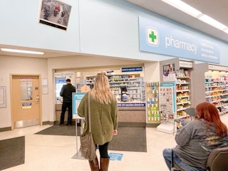 woman standing in line at walgreens pharmacy