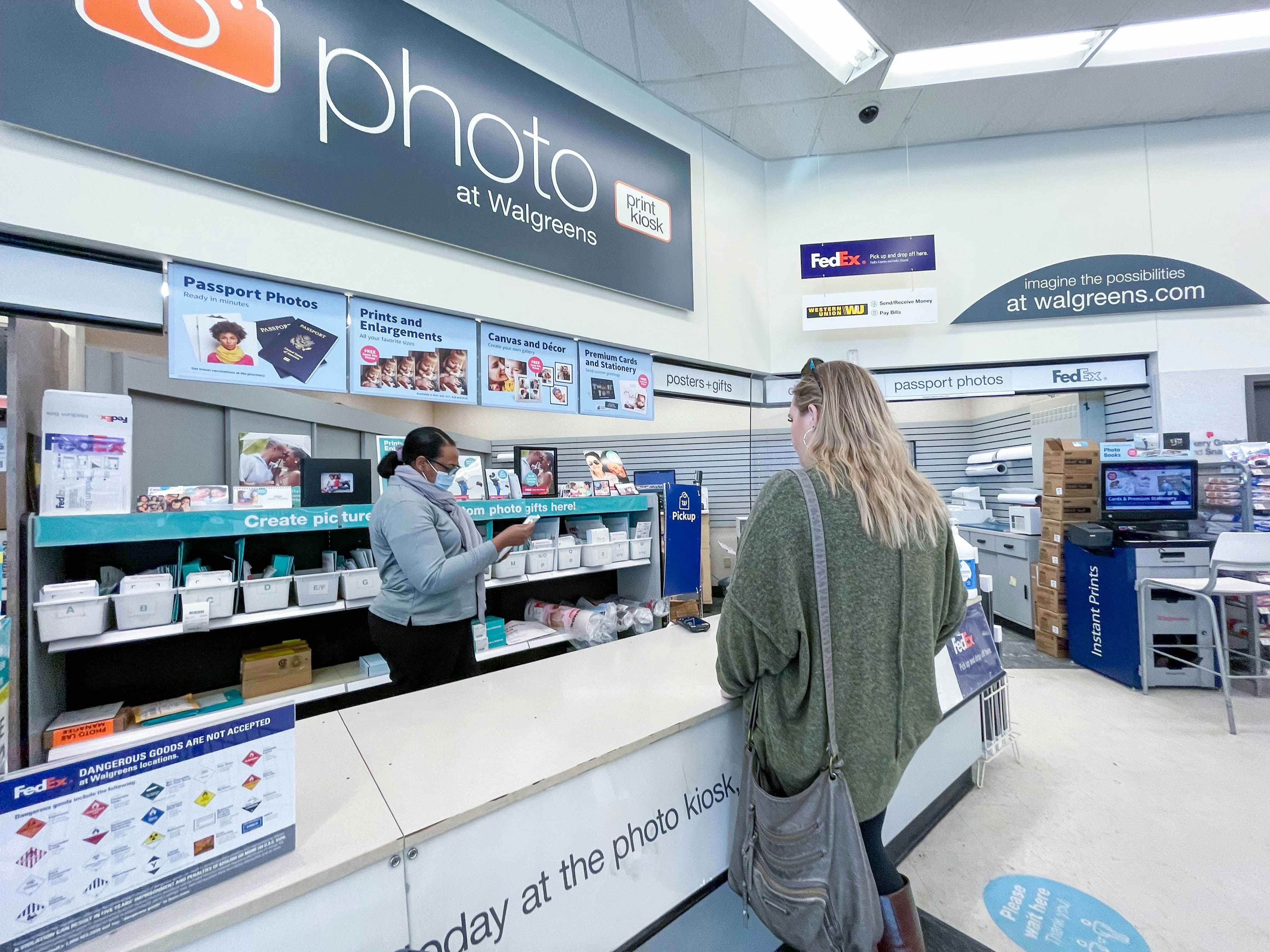 A woman standing at the Walgreens photo counter.