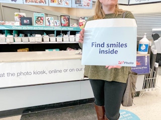 woman holding walgreens photo packet