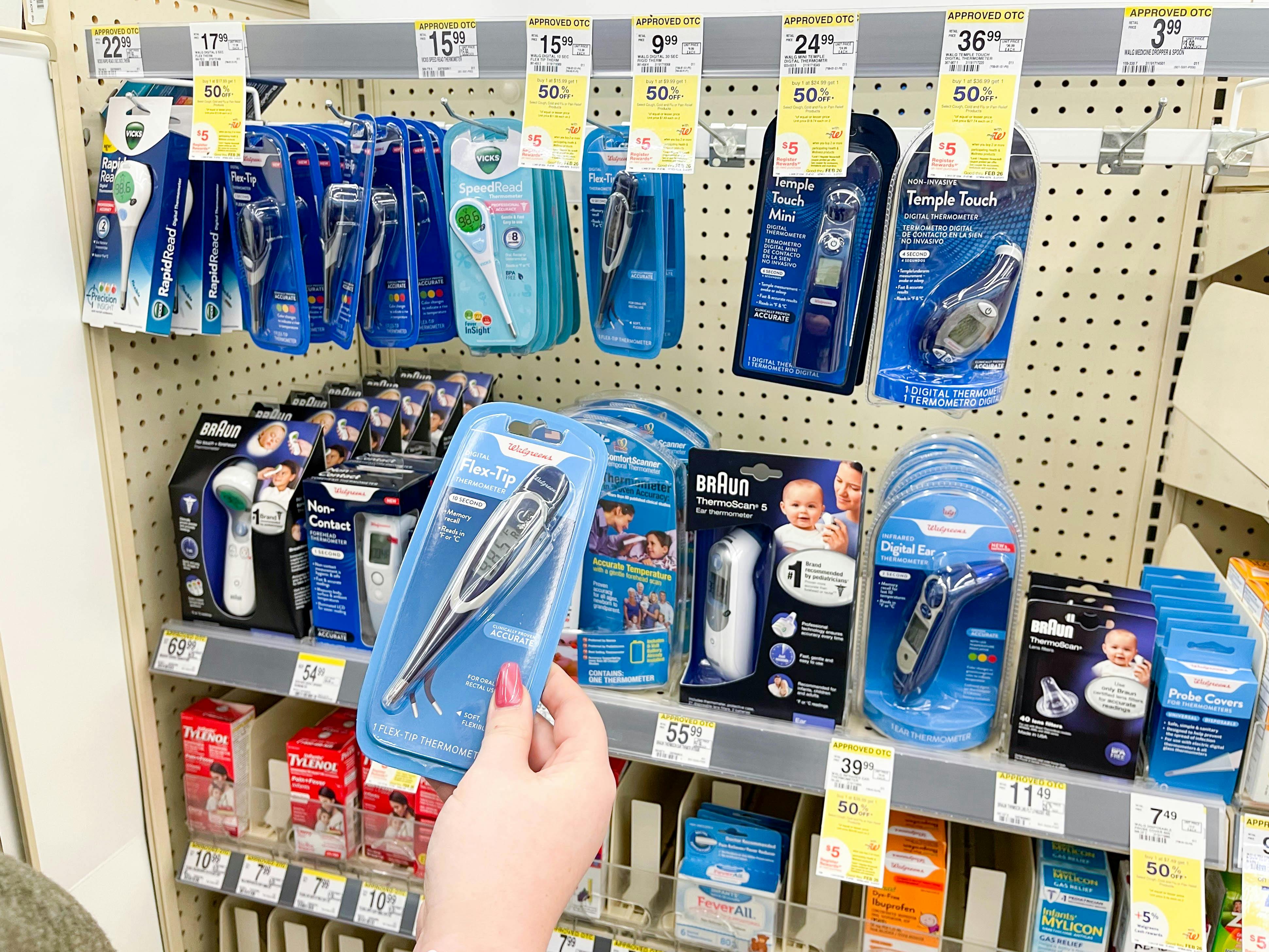 grabbing thermometers in store