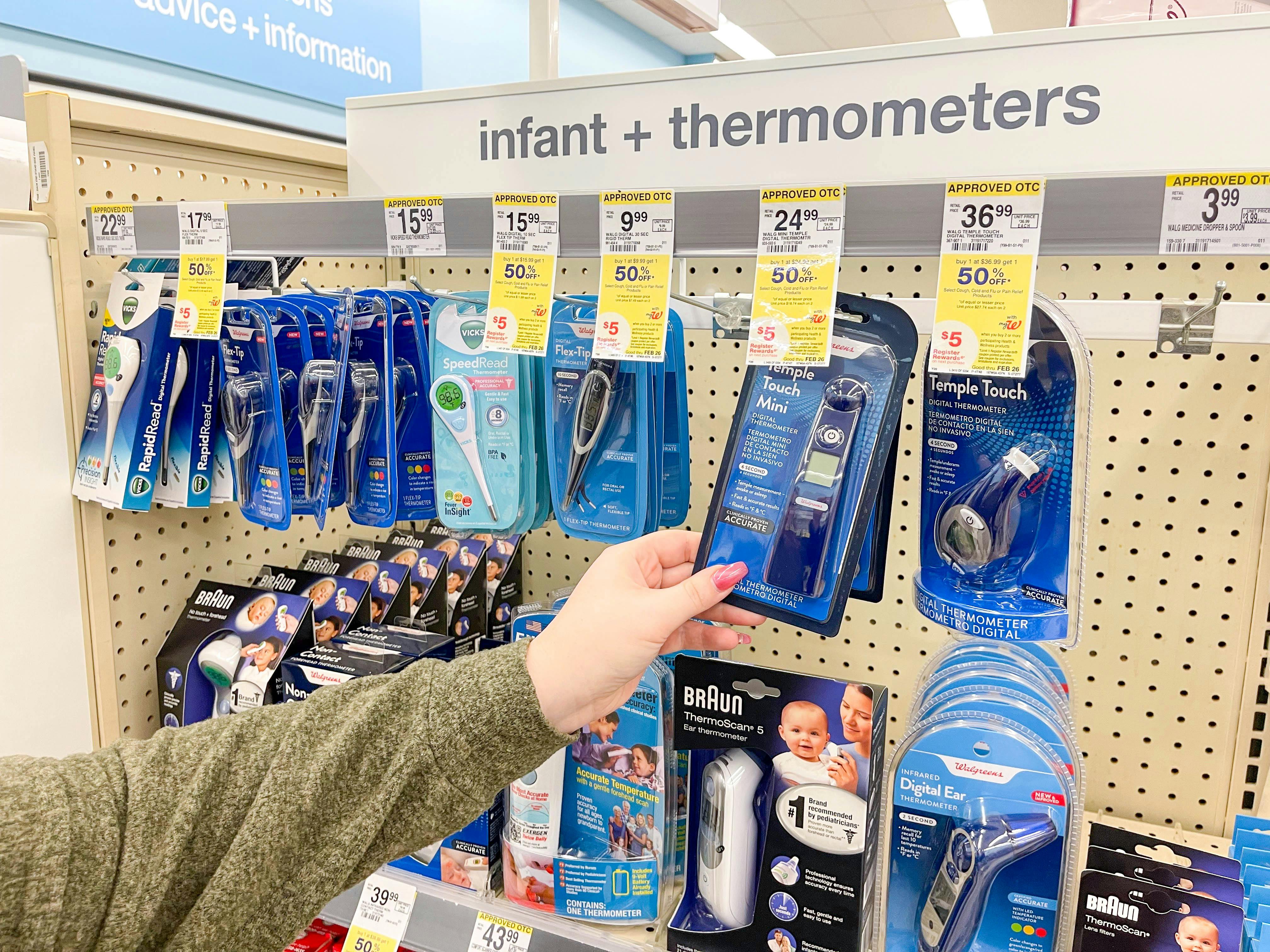 grabbing thermometers in store