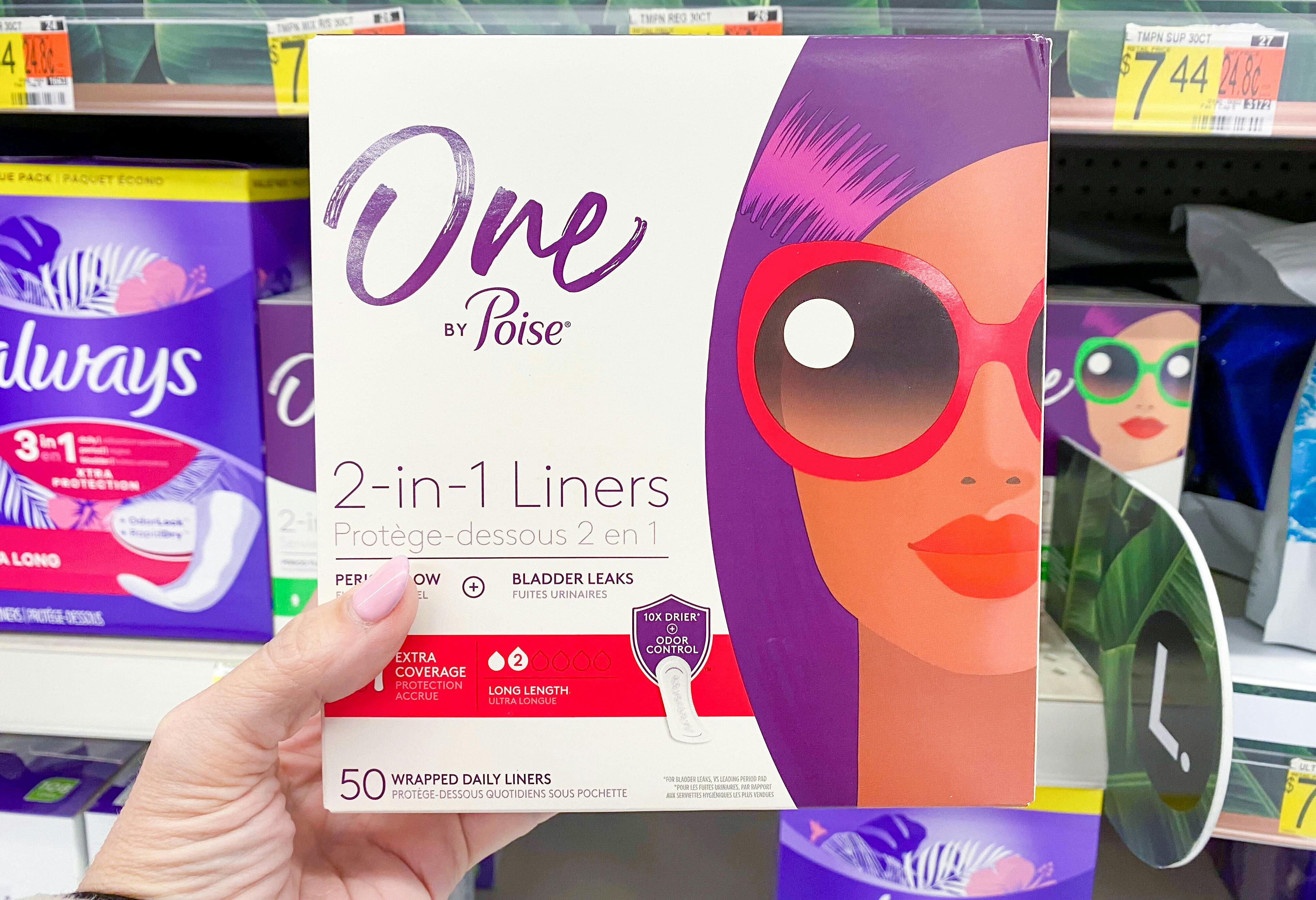 A person's hand holding up a box of One by Poise Liners in front of a shelf at Walmart