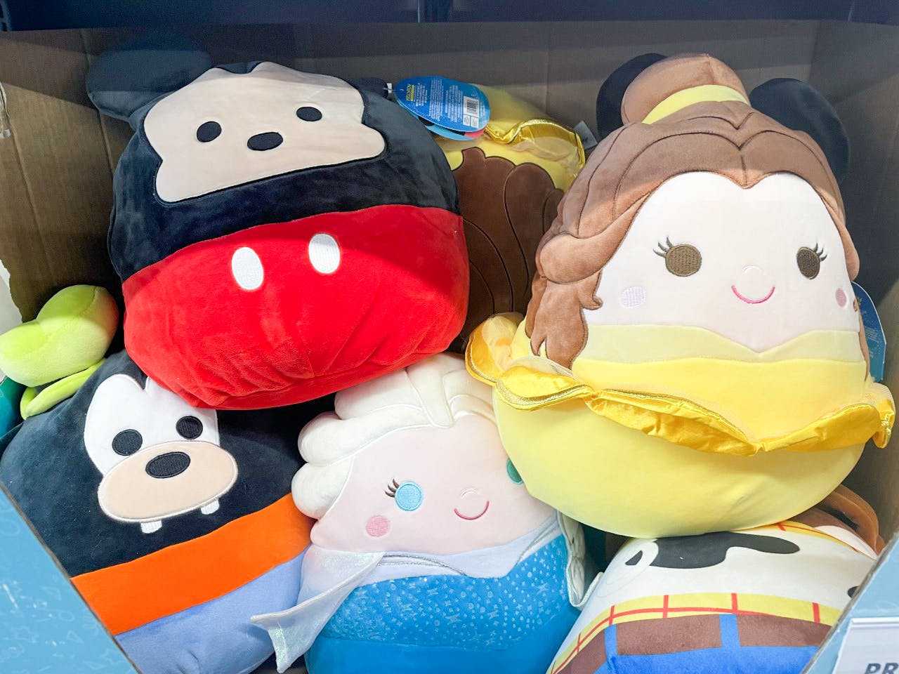 disney squishmallows in a pile with mickey, belle, goofy, and elsa at aldi
