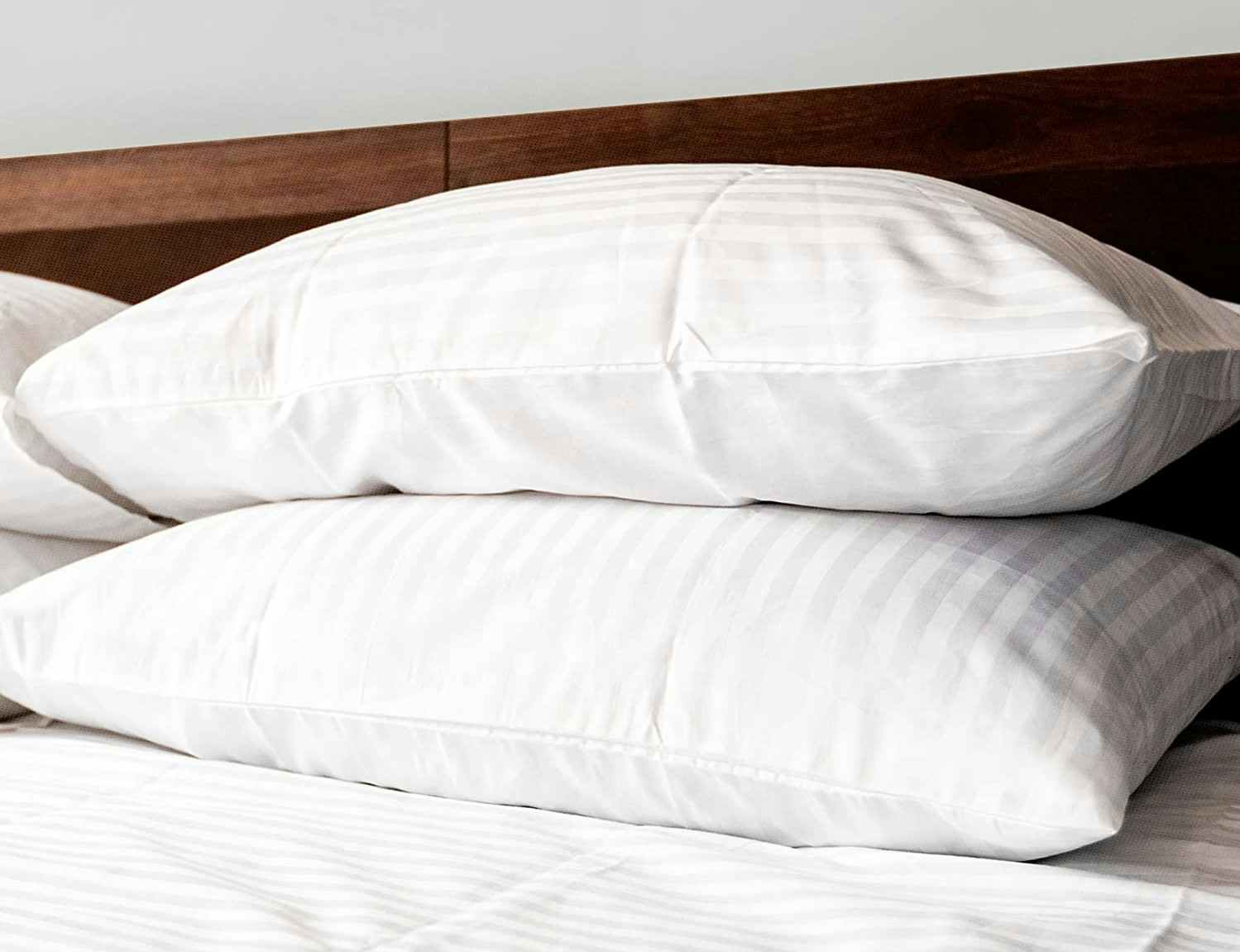 A set of Beckham Hotel Collection pillows on a bed.
