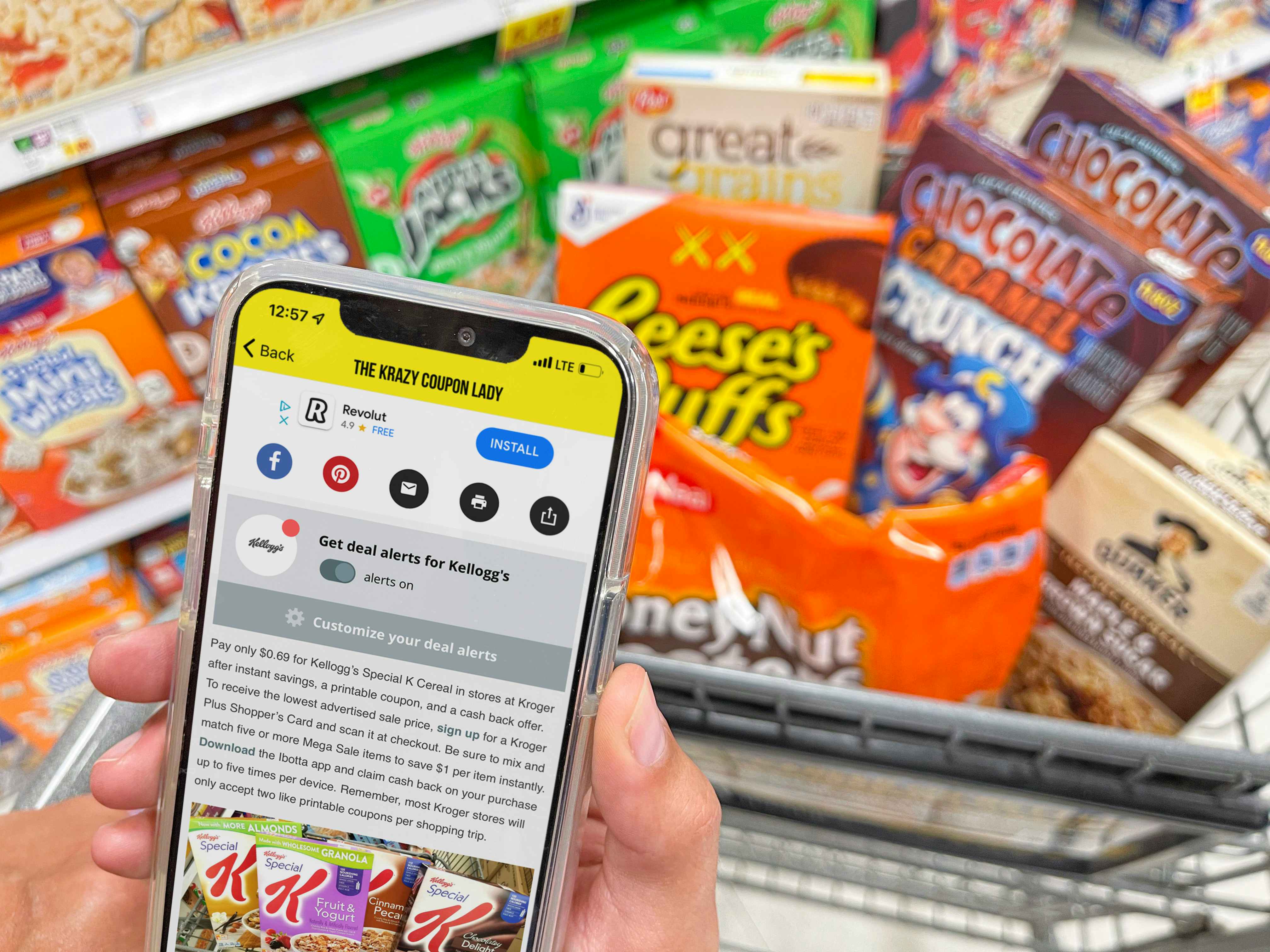 A person's hands holding a cellphone displaying the Krazy Coupon Lady mobile app's page for Kellogg's deals in front of a cart full of Kellogg's brand cereal.
