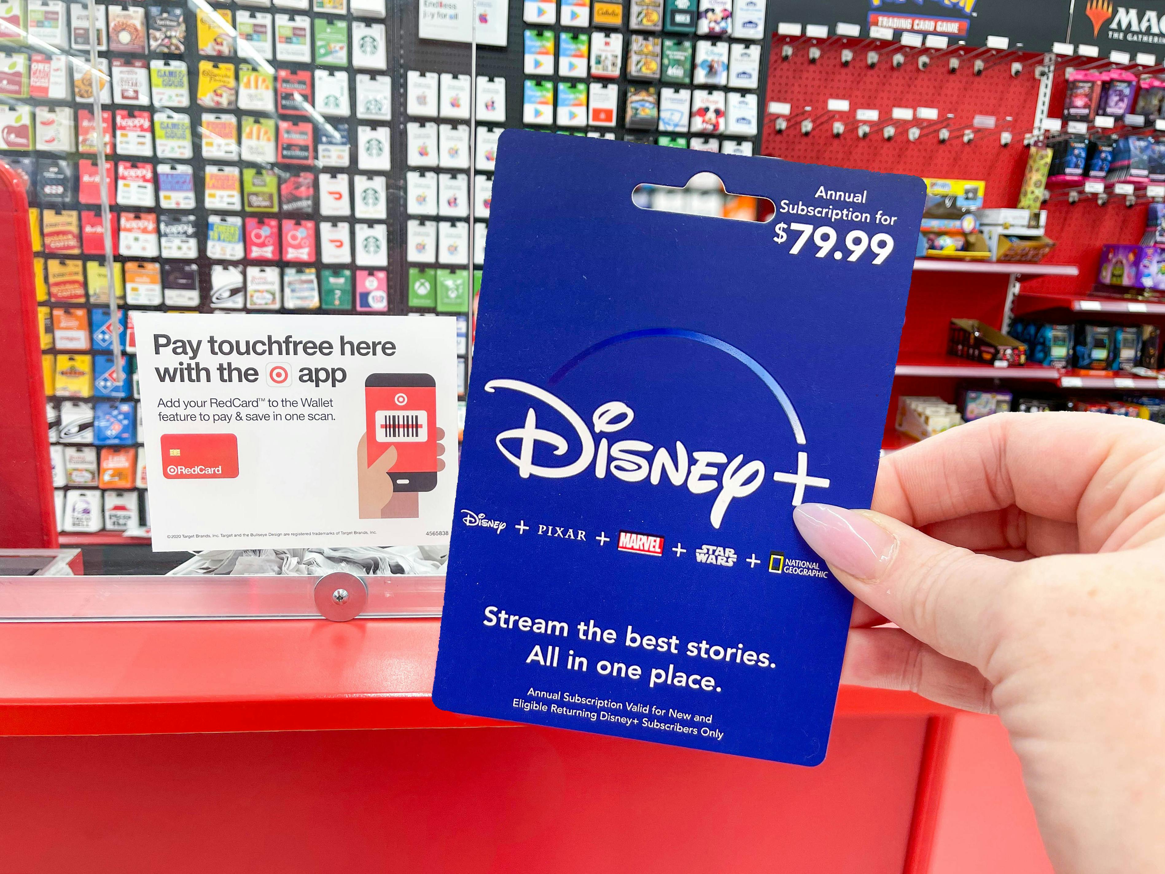 person holding disney plus gift card in target